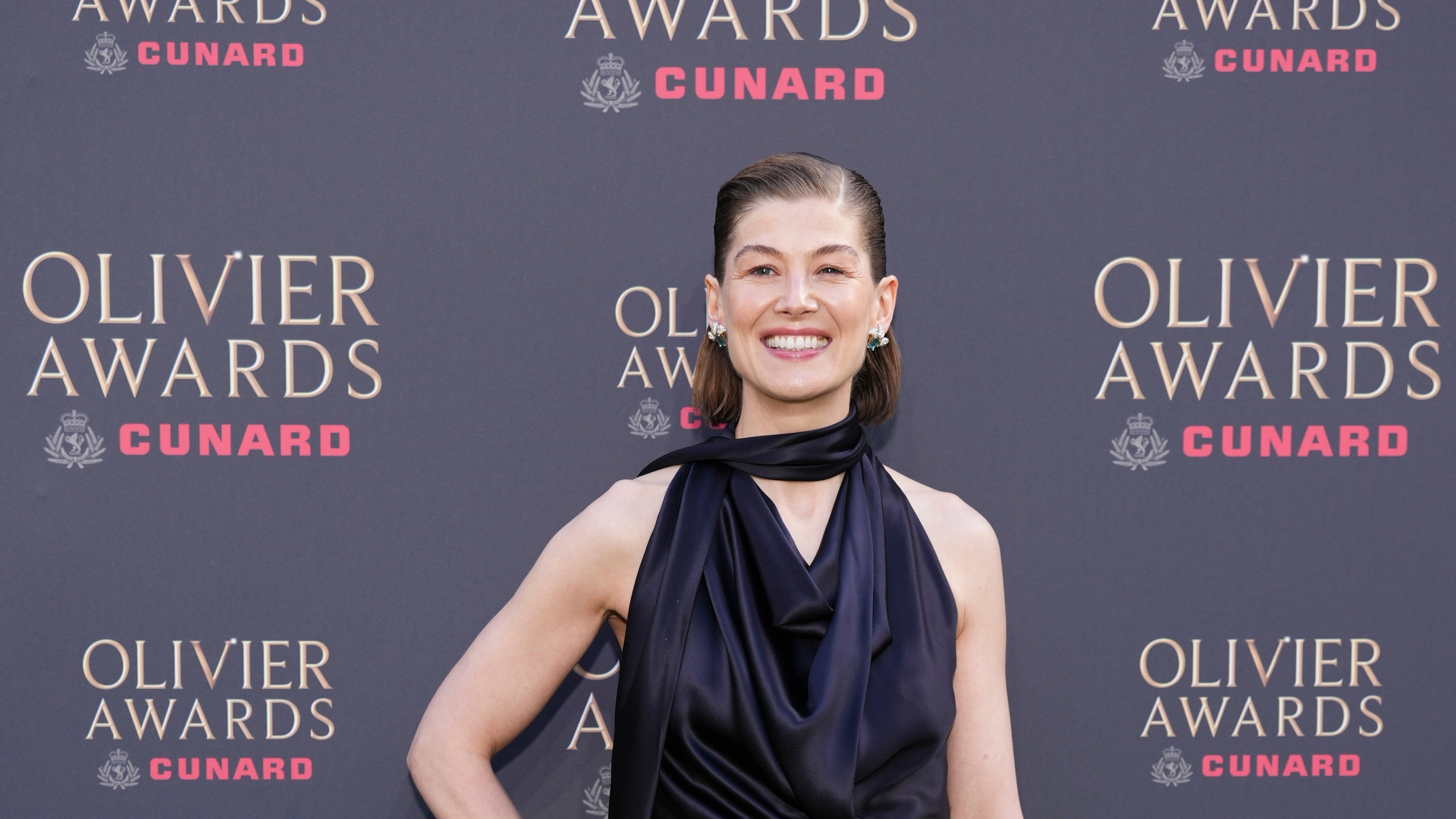 Rosamund Pike poses for photographers upon arrival at the Olivier Awards in London, England, Sunday, April 12, 2026. (Photo by Scott A Garfitt/Invision/AP)