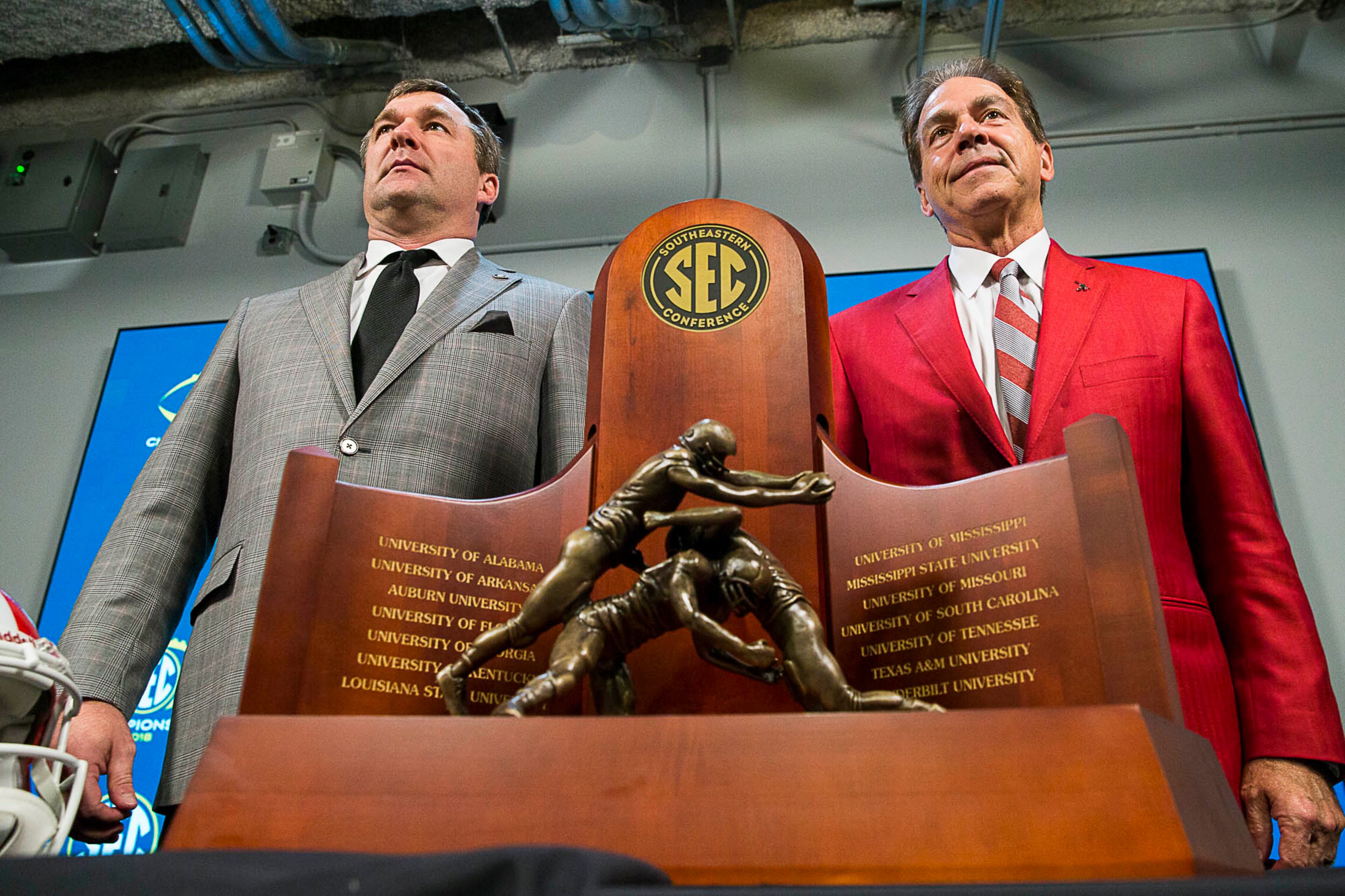 11/30/2018 -- Atlanta, Georgia -- University of Georgia head football coach Kirby Smart (left) and University of Alabama head coach Nick Saban (right) stand for a photo with the SEC Championship trophy during a press conference at Mercedes Benz Stadium, Friday, November 30, 2018. Georgia will play the University of Alabama in the 2018 SEC Championship game on Saturday (ALYSSA POINTER/ALYSSA.POINTER@AJC.COM)