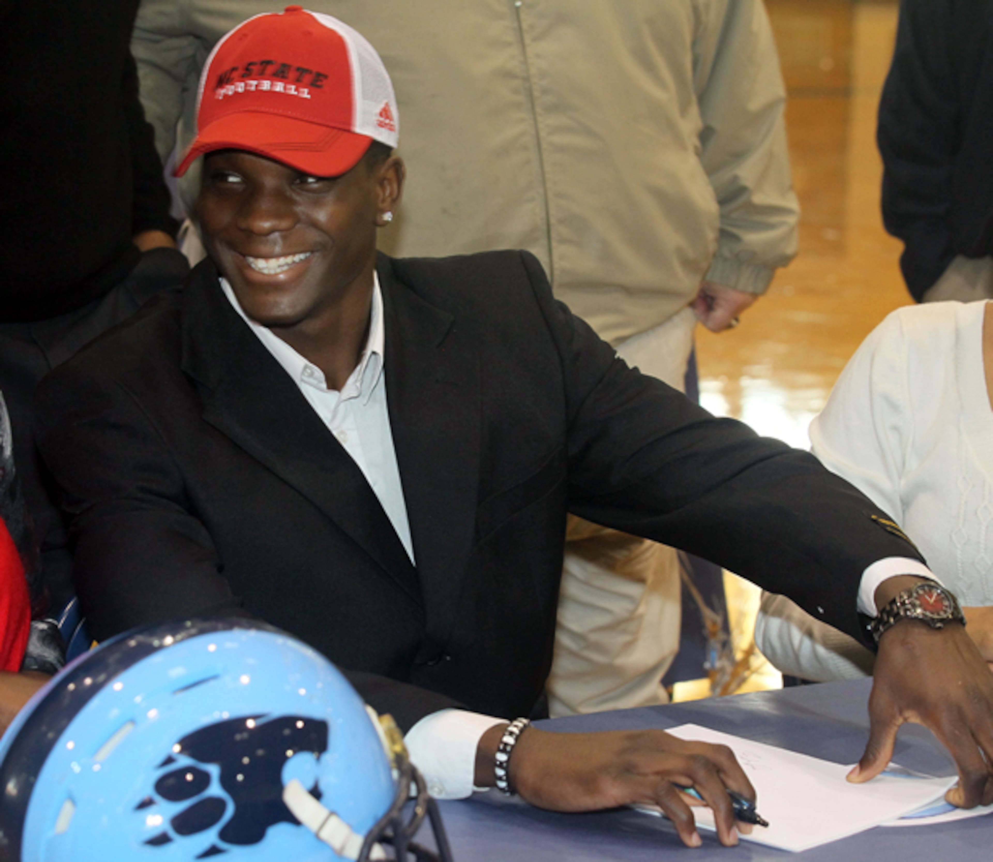 Former Georgia Tech recruit Jumichael Ramos, 6-3, 190-pound basketball-turned-football star, signs a commitment to play for N.C. State in the Lovejoy High School gymnasium in Hampton during National Signing Day.