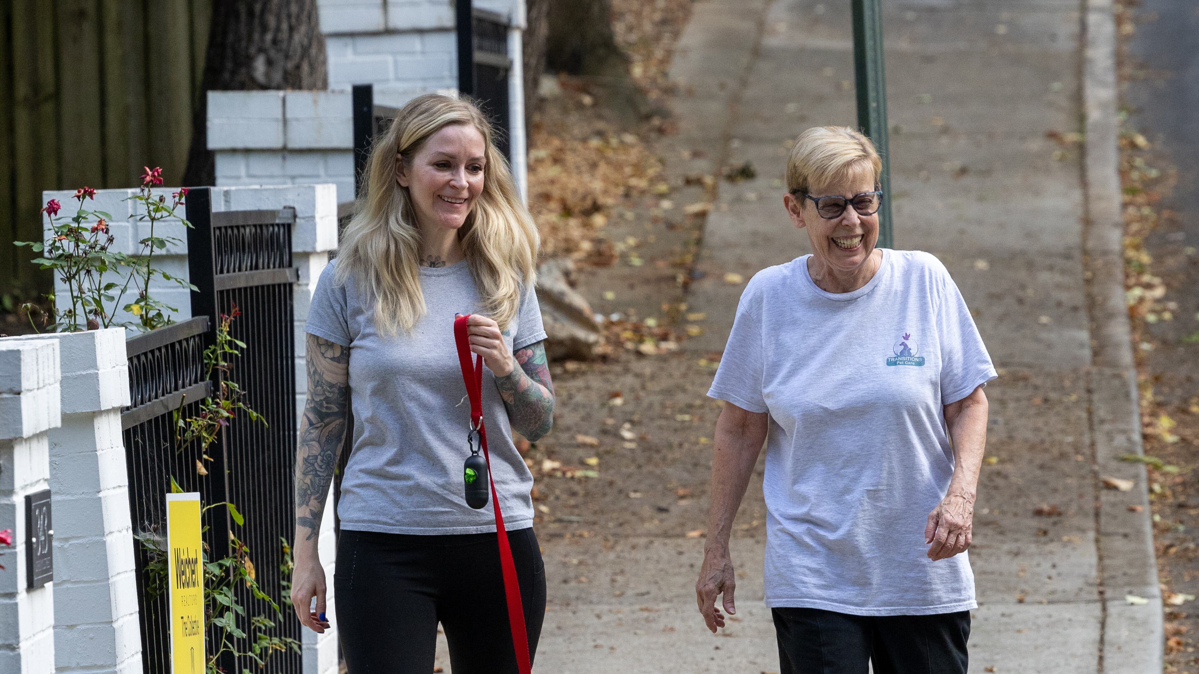 Beverly Means (left) and volunteer Lois Gross walk a dog for a client in Decatur, one of the many services provided by Transitions Pet Care. (Phil Skinner for the AJC)