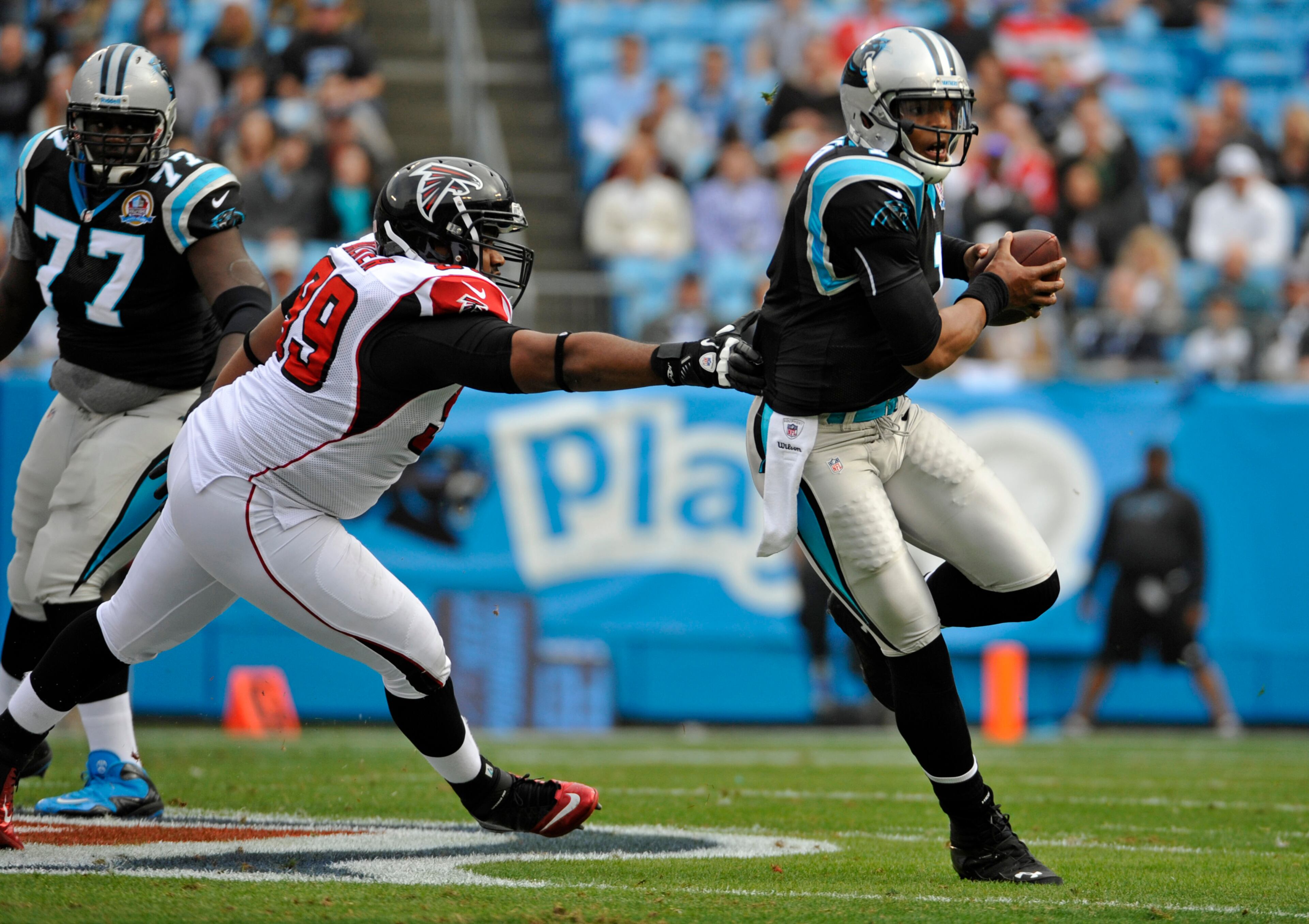 Carolina Panthers' Cam Newton (1) scrambles for a gain as Atlanta Falcons' Vance Walker (99) chases during the first half of an NFL football game in Charlotte, N.C., Sunday, Dec. 9, 2012. (AP Photo/Rainier Ehrhardt)