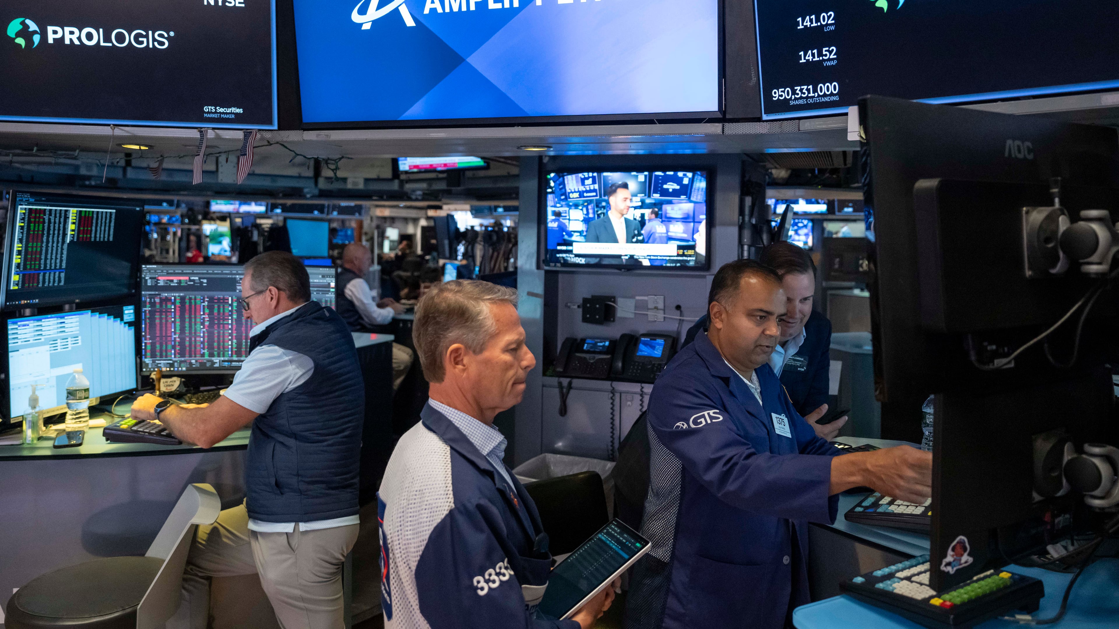 Specialists Dilip Patel, right, and Trader Robert Charmak, center, work on the floor of the New York Stock Exchange, Thursday, Aug. 27, 2026, in New York. (AP Photo/Yuki Iwamura)
