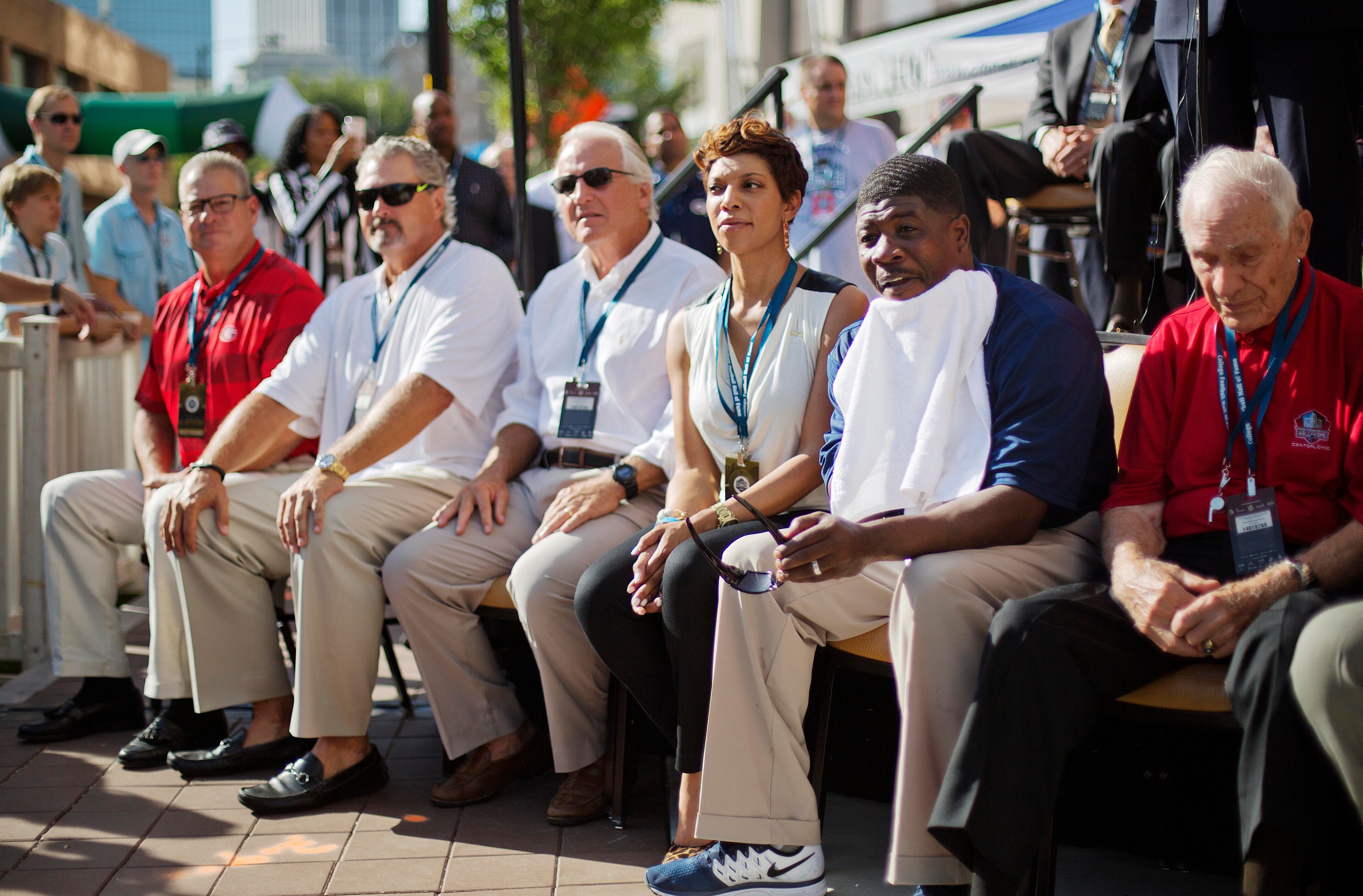 Former Georgia Tech quarterback and College Football Hall of Fame inductee Joe Hamilton, second from right, sits with fellow inductees during a ceremony for the grand opening, Saturday, Aug. 23, 2014, in Atlanta. The new high-tech hall features an interactive experience that begins when the guest registers for a smart pass, selects a favorite school and then sees that school's helmet illuminated. (AP Photo/David Goldman)