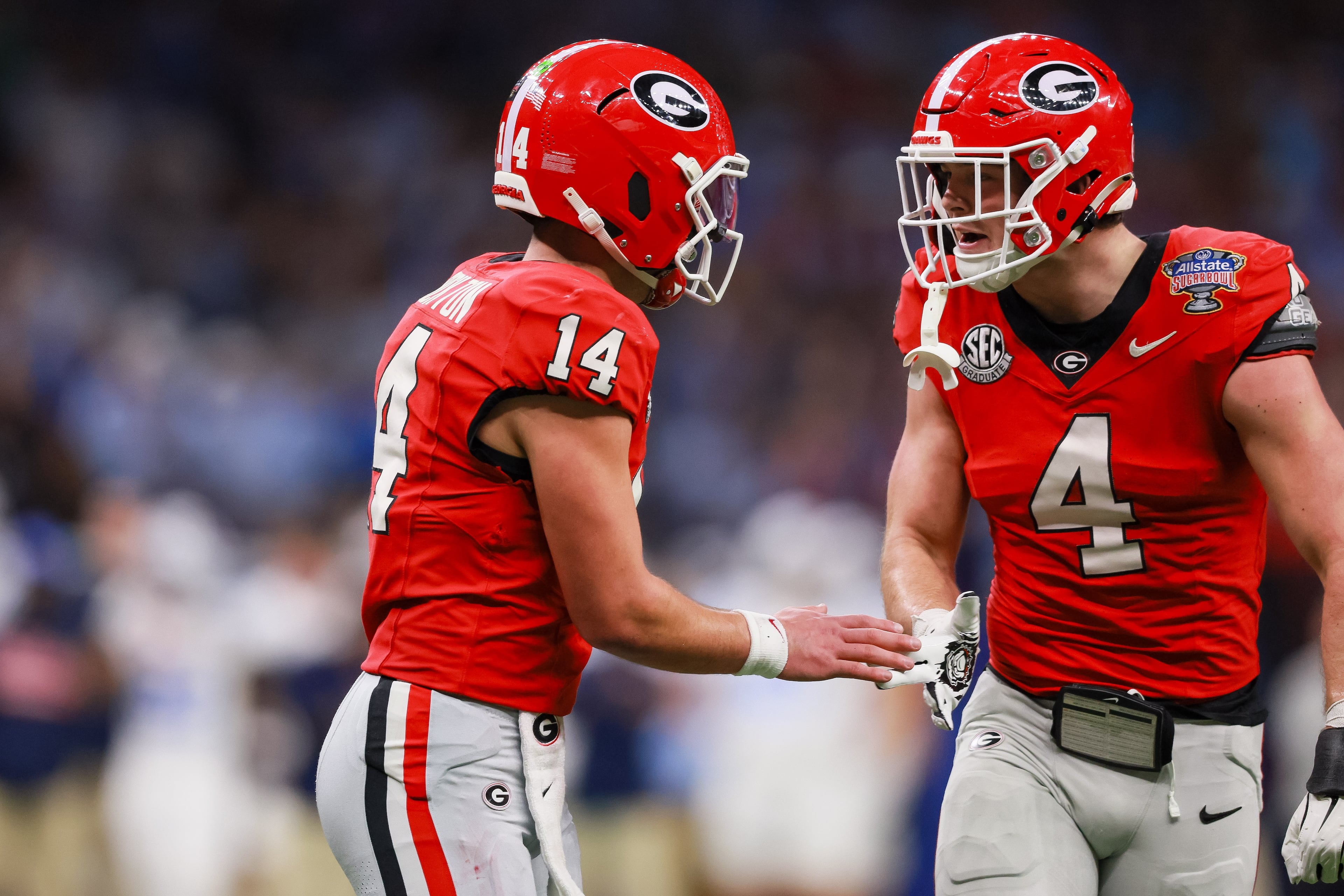 Georgia Bulldogs tight end Oscar Delp (4) and quarterback Gunner Stockton (14) react after a first down against the Ole Miss Rebels during the first half of the NCAA College Football Playoff quarterfinal game at the Sugar Bowl in the Caesars Superdome, Thursday, Jan. 1, 2026, in New Orleans. (Jason Getz/AJC)
