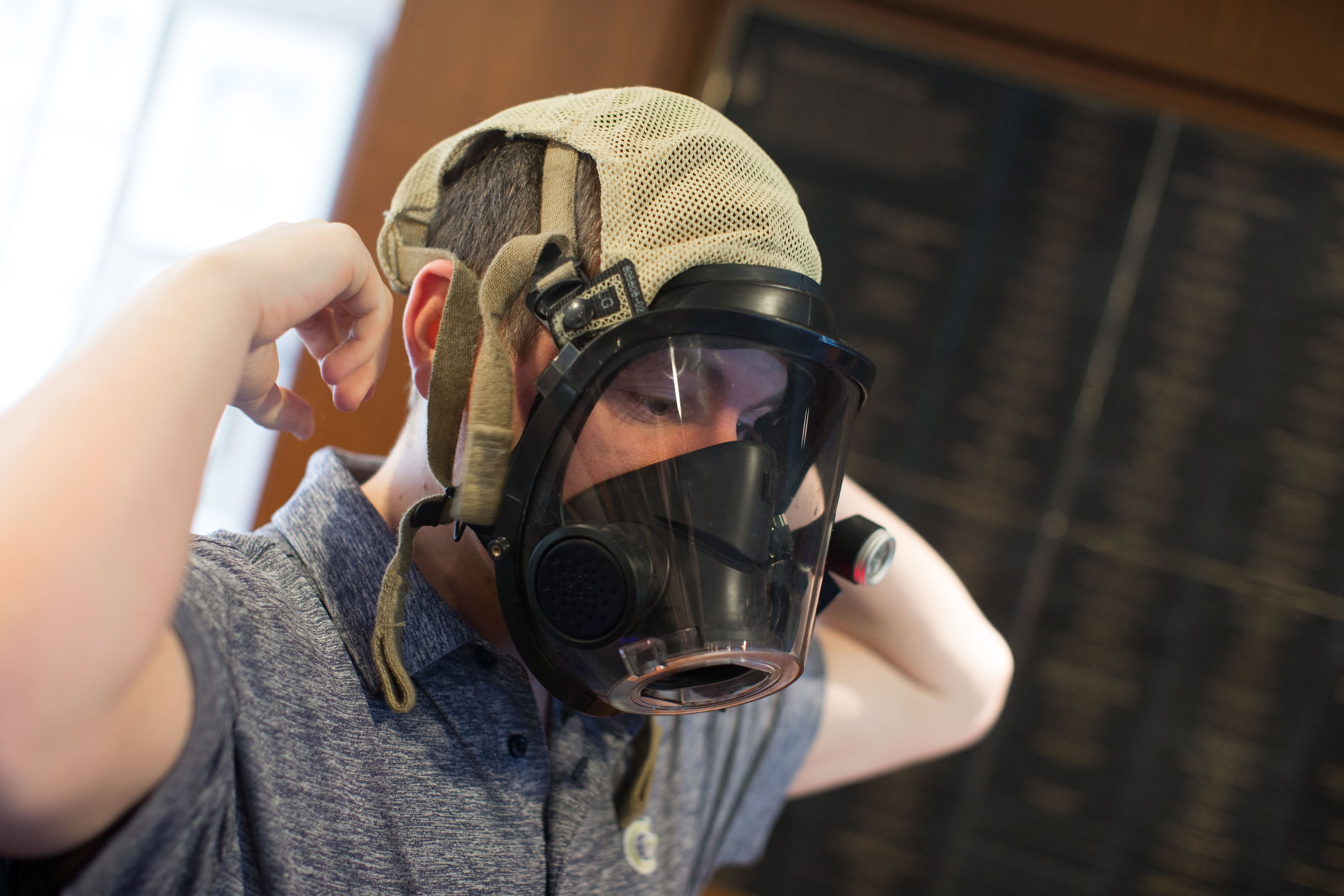 Georgia Tech student Zachary Braun puts on a fire mask with a FireHUD attached, a device that sends real-time data to fire fighters in hazardous conditions. Braun created FireHUD alongside fellow Georgia Tech student Tyler Sisk, who is not pictured. BRANDEN CAMP/SPECIAL
