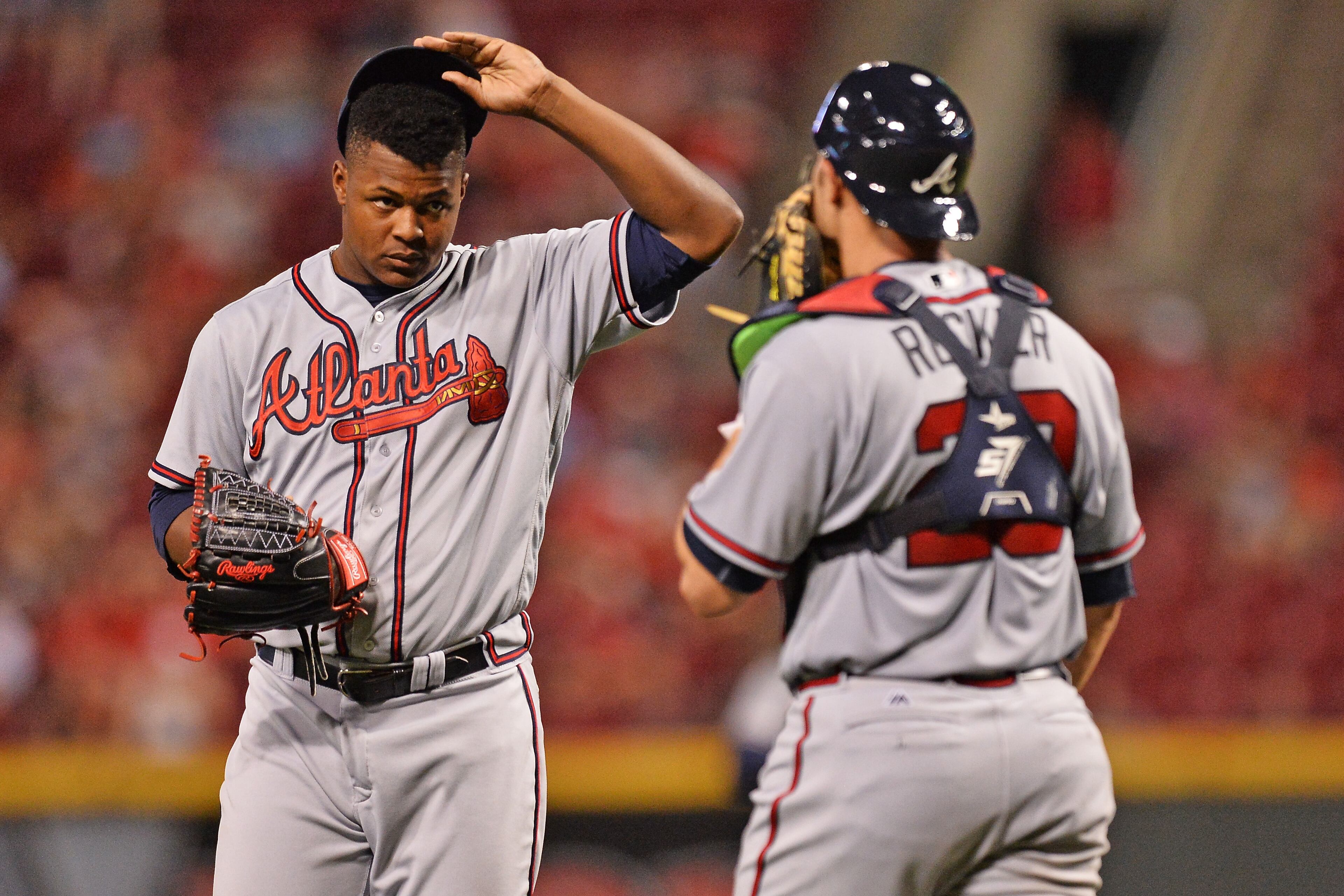 CINCINNATI, OH - JULY 19: Pitcher Mauricio Cabrera #62 of the Atlanta Braves and catcher Anthony Recker #20 of the Atlanta Braves talk at the mound in the tenth inning against the Cincinnati Reds at Great American Ball Park on July19, 2016 in Cincinnati, Ohio. Atlanta defeated Cincinnati 5-4 in 11 innings. (Photo by Jamie Sabau/Getty Images)