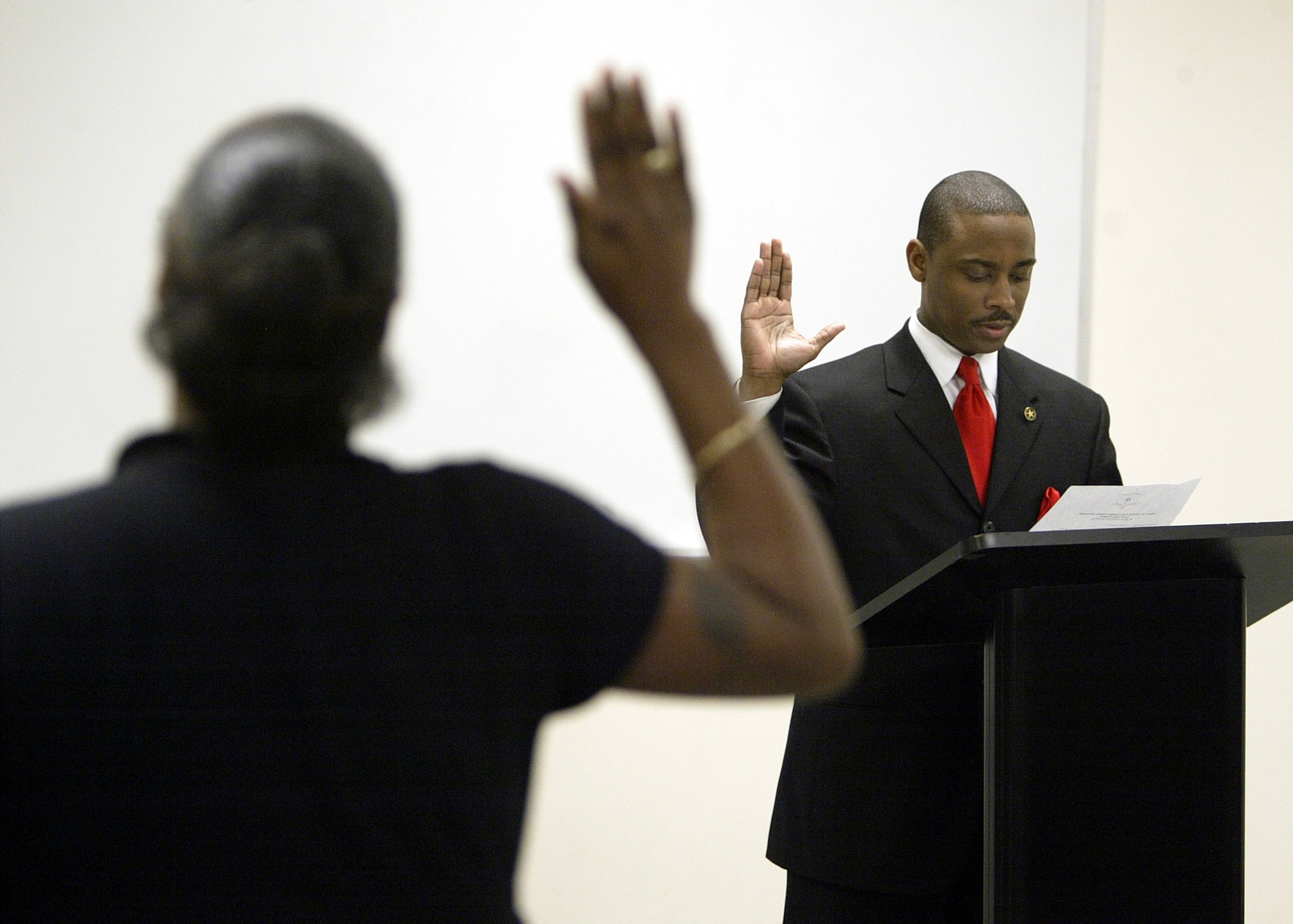 January 1, 2005: On his first official day as Clayton sheriff, Hill fired 27 officers and had them escorted from the building with snipers posted on the roof. In this photo, Hill swears in corrections officers at the Clayton County Sheriff's Department. (Brant Sanderlin / AJC 2005 photo)