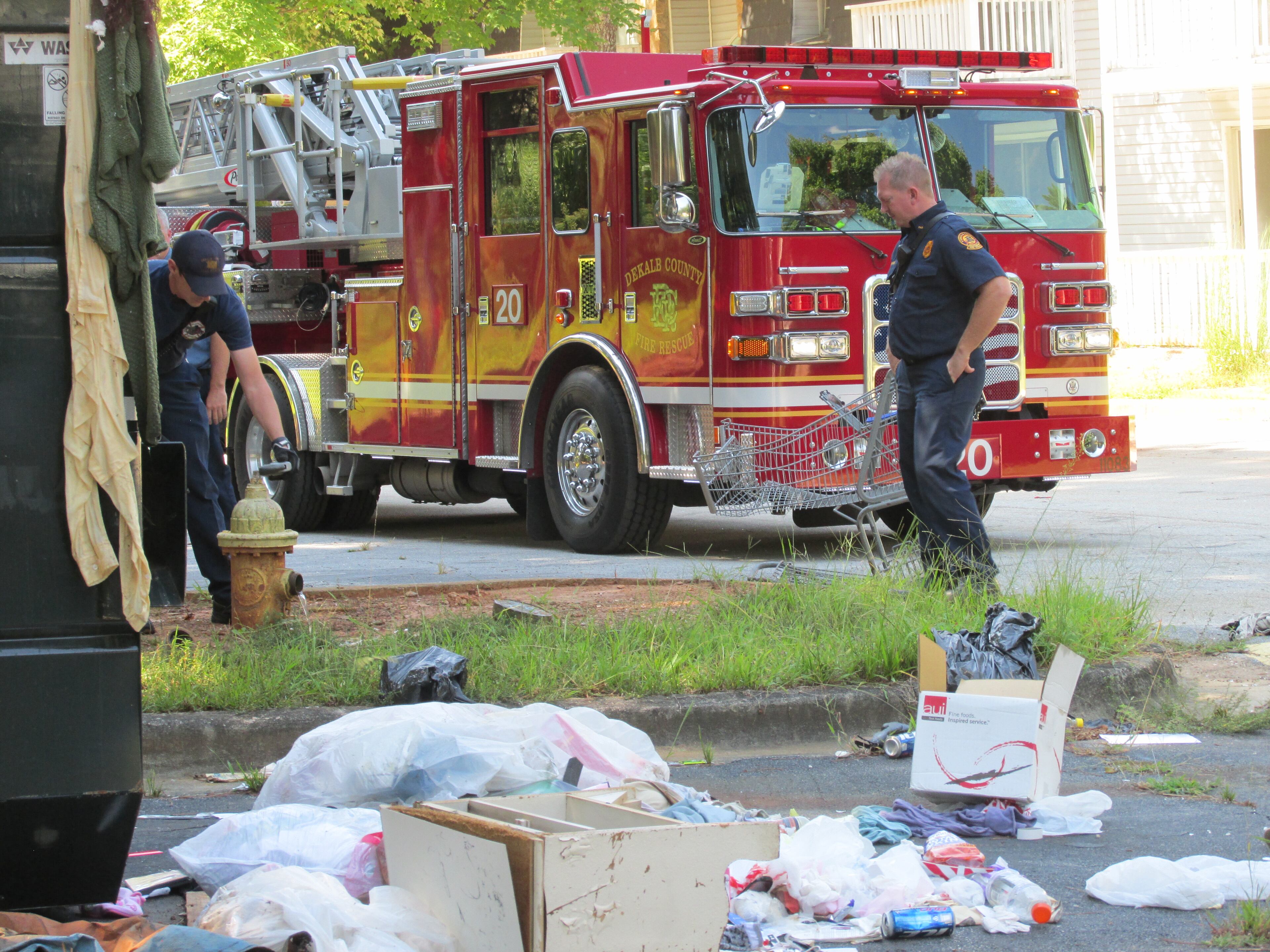 DeKalb Commissioner Nancy Jester on Tuesday called attention to the condition at Creekside Forest apartments off I-20, which she said have been failed by the county and management. County firefighters stopped by to check hydrants. (Photo by Joshua Sharpe)