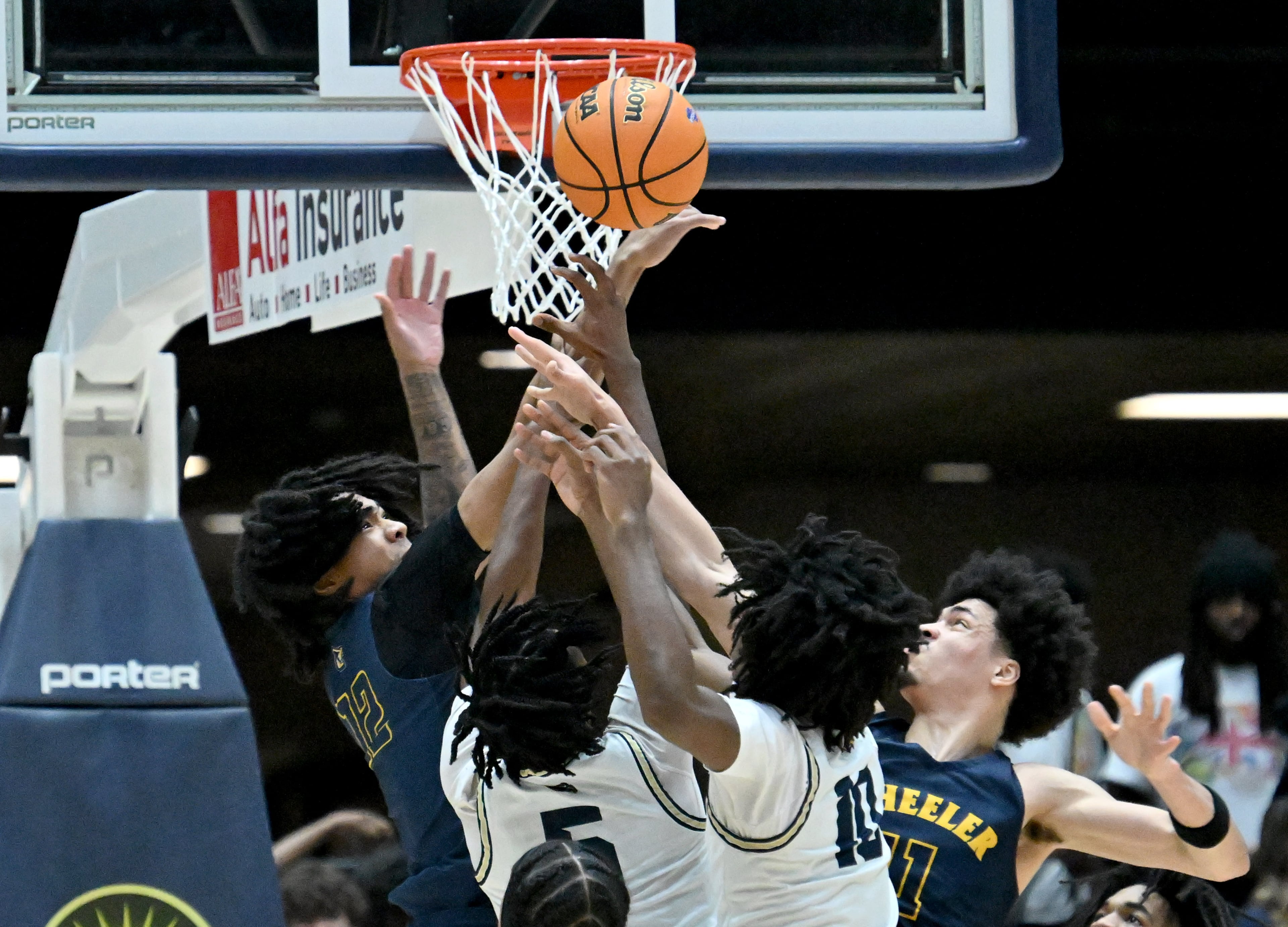 Wheeler Shamar Madden (left) and Wheeler Amare James (right) fight for a rebound against Pebblebrook Michael Setrana (5) and Pebblebrook Donald McMillian (10) during the first half in Class 6A Boys GHSA State Championship at the Macon Coliseum, Saturday, March 14, 2026, in Macon. Wheeler won 62-52 over Pebblebrook. (Hyosub Shin/AJC)