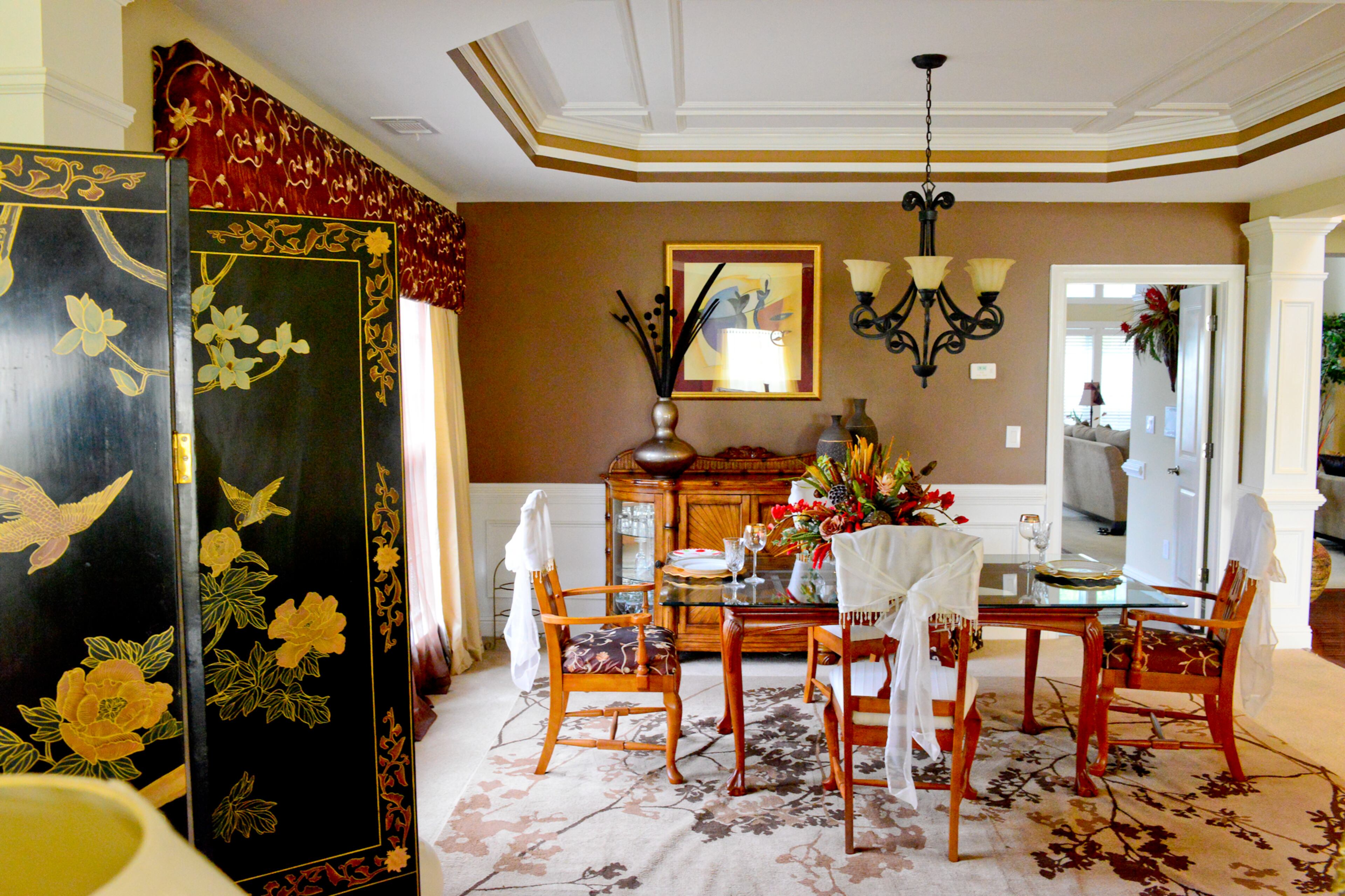 Mocha paint and ceiling details provide a soothing atmosphere for a delicious meal in the dining room. White satin chair covers provide a classy touch to a table and chairs she's owned for several years. Frances Pace created the window treatments, based in her design on an idea she saw in a model home.