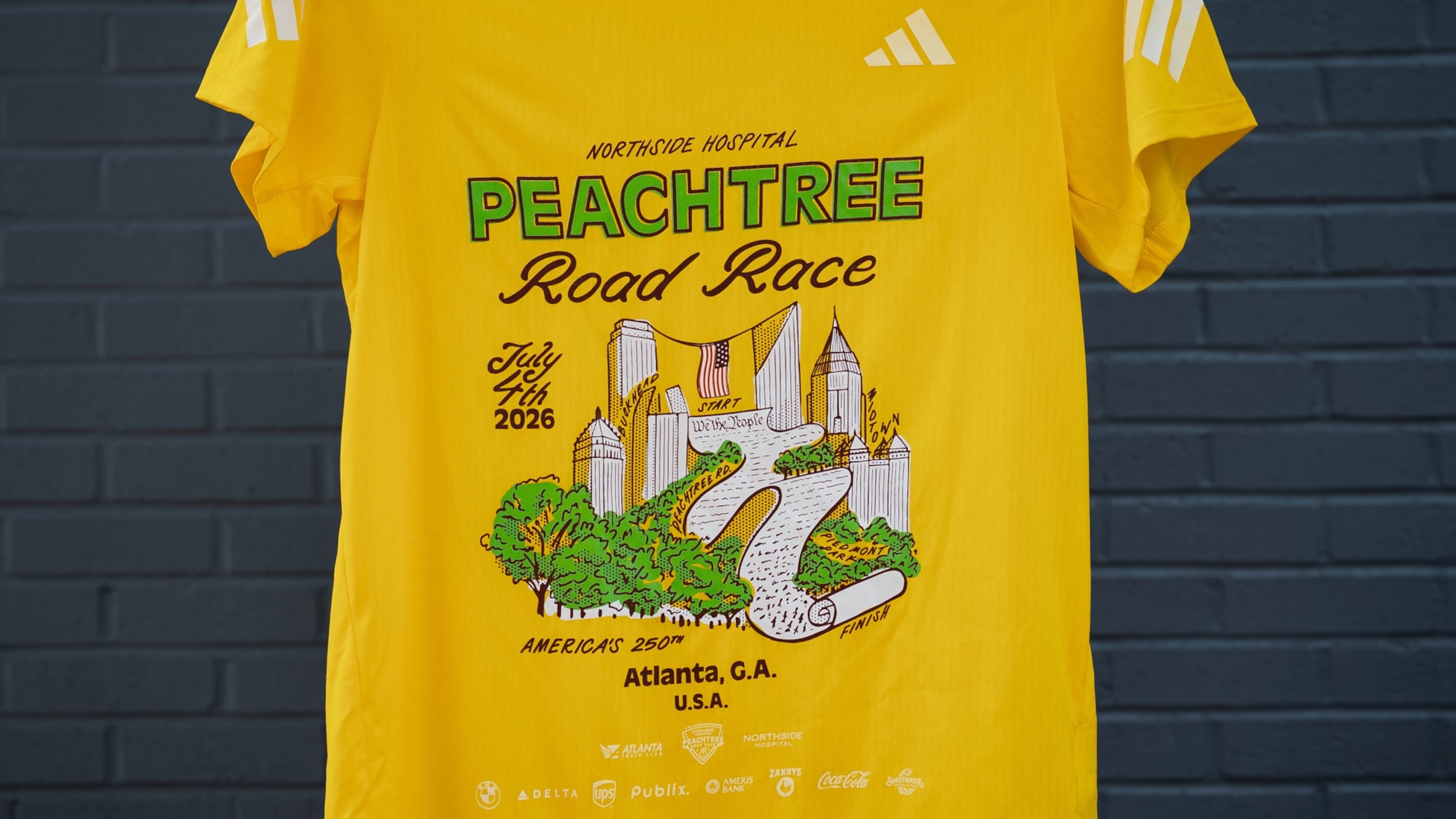 The 2026 Peachtree T-shirt design, ‘We the Peaches,’ was created by Dyan Szall. (Courtesy Atlanta Track Club)
