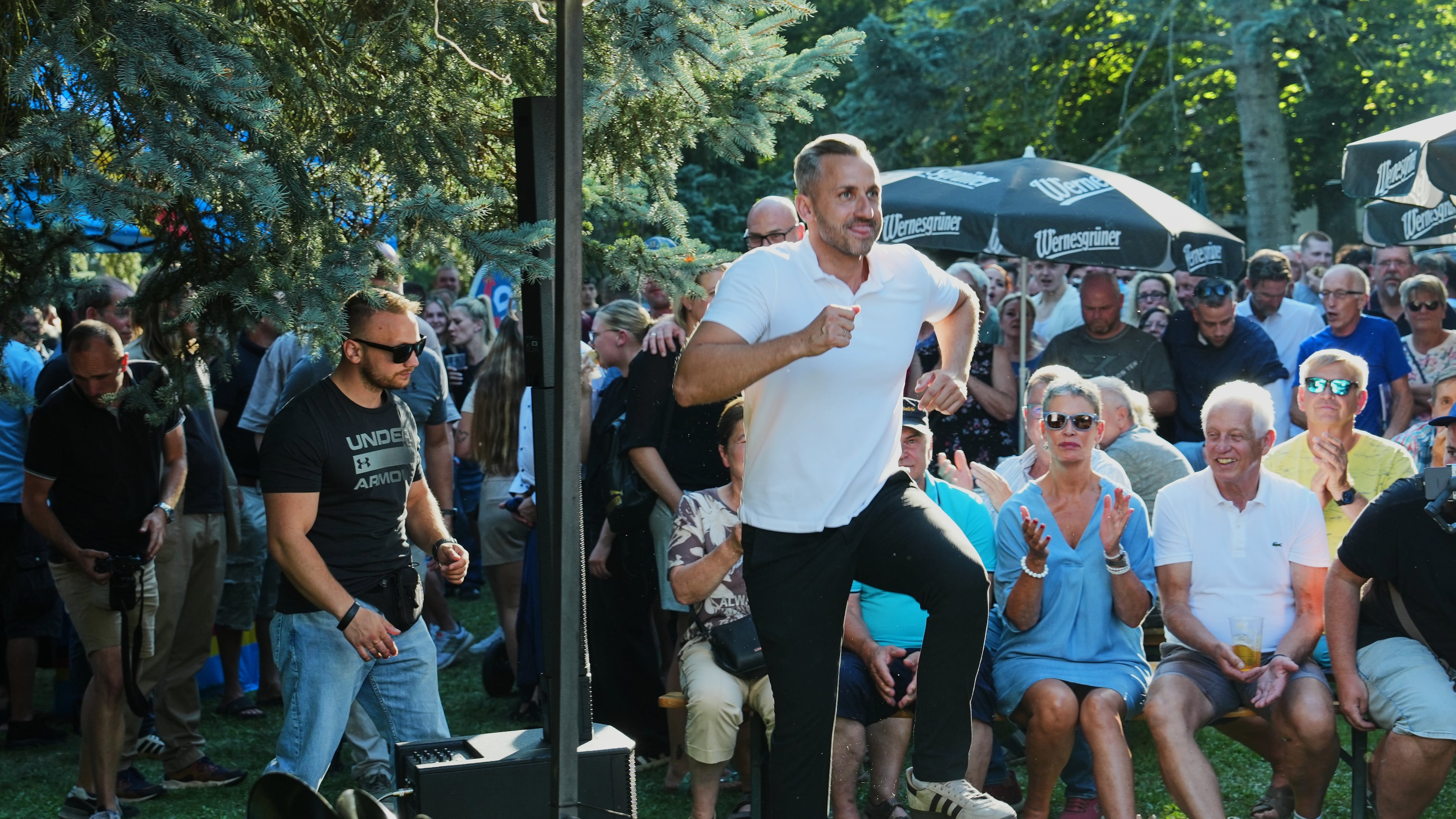 Ulrich Sigmund, the top candidate for the "Alternative for Germany" (AfD) party in the state elections in Saxony-Anhalt, enters the stage at a campaign barbecue hosted by the party in Moeser, Germany, Thursday, Aug. 13, 2026. (AP Photo/Markus Schreiber)