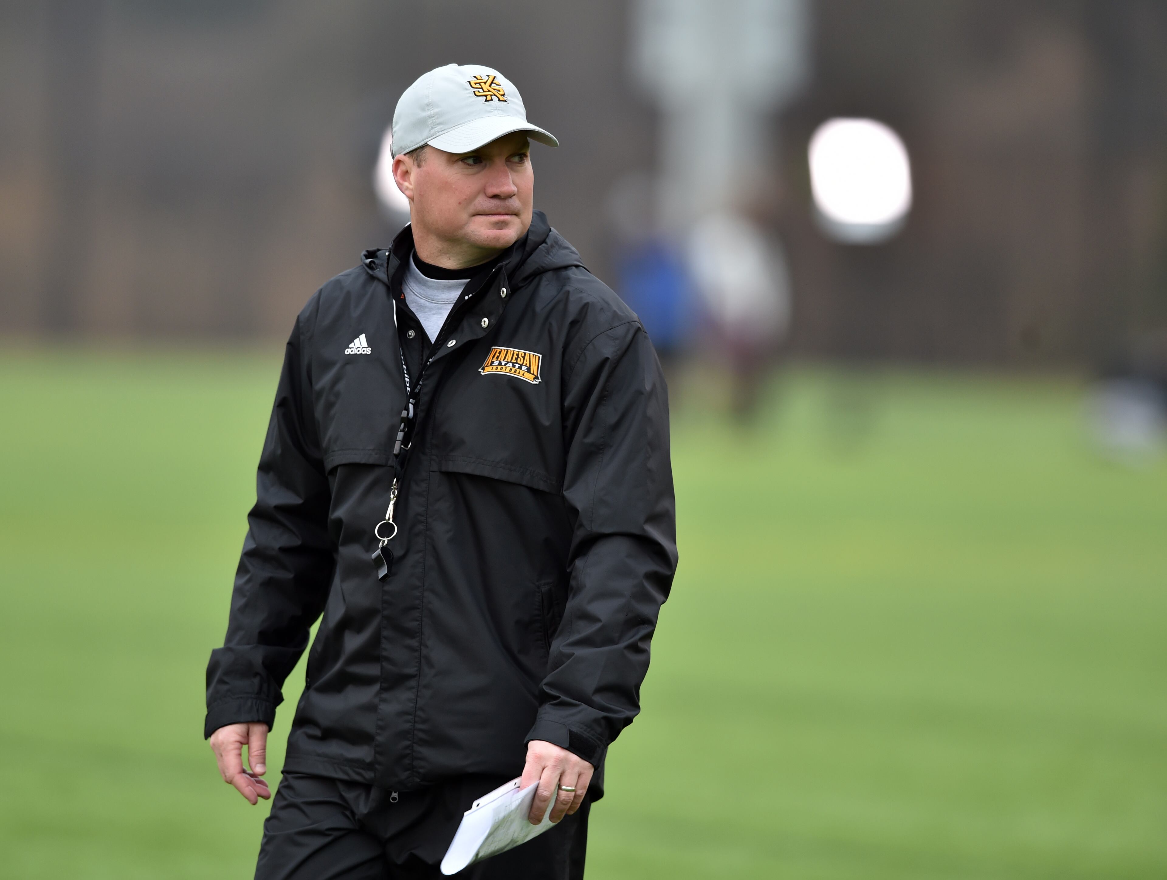 Kennesaw State head coach Brian Bohannon overlooks the team during the Owls' first spring practice Monday, March 2, 2015, in Kennesaw.