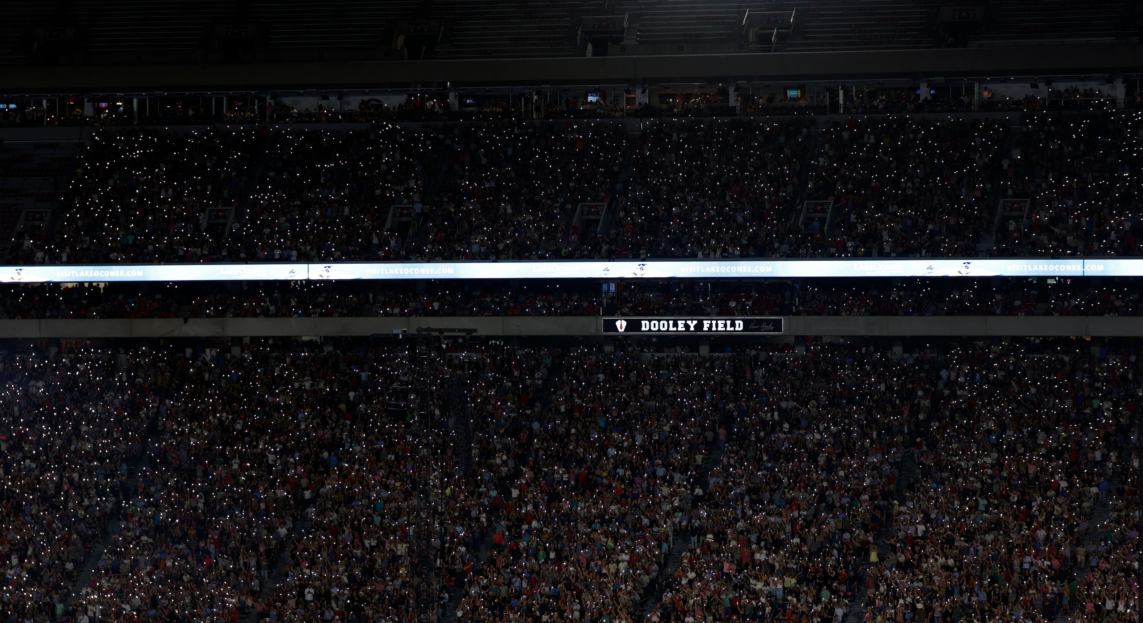 Fans light up Sanford Stadium with their cellphone flashlights in anticipation of Jason Aldean and Luke Bryan taking the stage Saturday, April 25, 2026, in Athens. (Akili-Casundria Ramsess/EyeAkili Media)