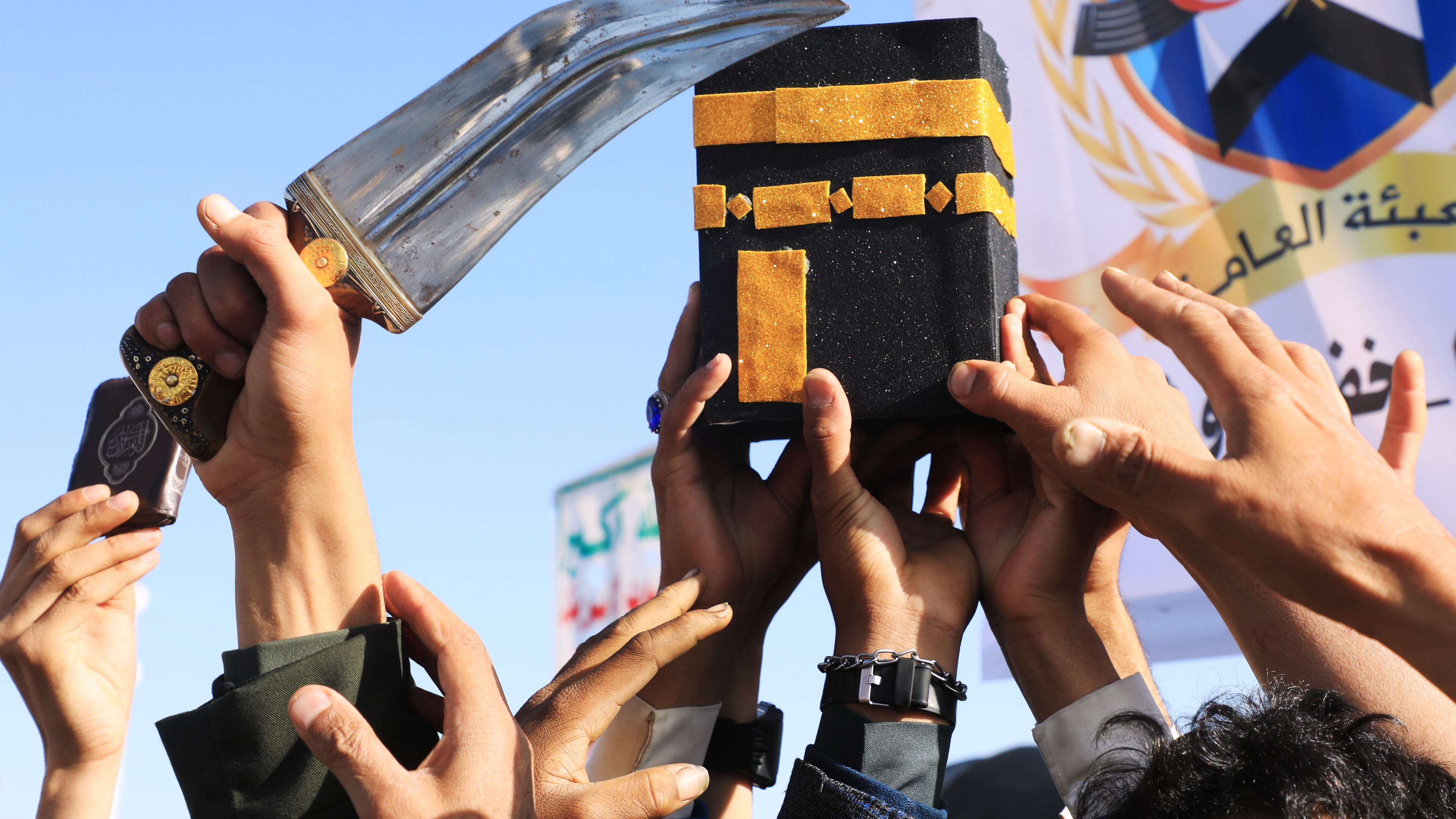 Supporters of Yemen's Houthi rebels raise a mock of the Kaaba, Islam's holiest site, during a rally in support of the group and to protest Saudi Arabia's accusation that the Houthis targeted Islam's holiest site of Mecca, in Sanaa, Yemen, Friday, Oct. 9, 2026. (AP Photo/Osamah Abdulrahman)