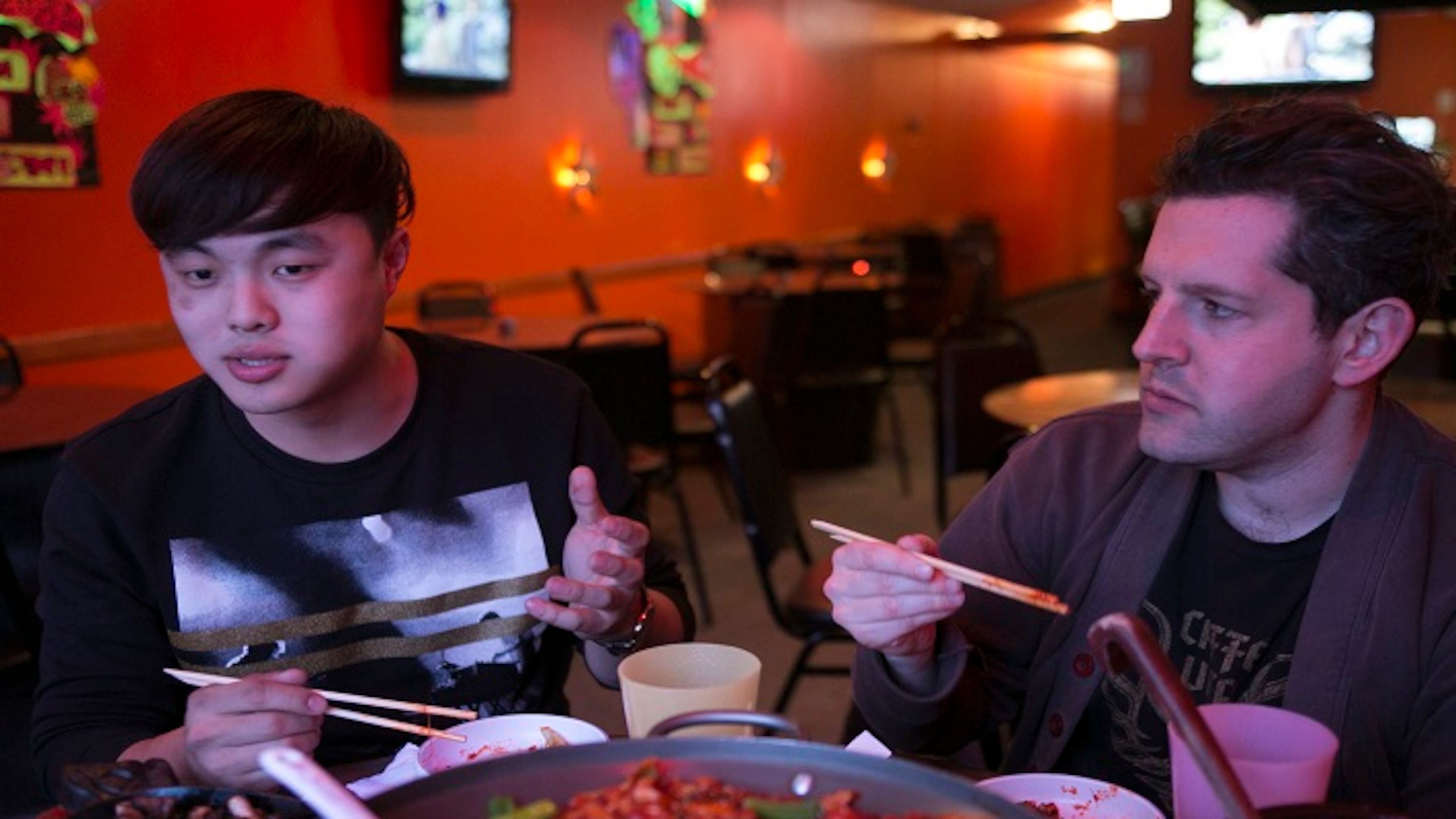 Deuki Hong and Matt Rodbard, authors of the cookbook "Koreatown," talk over dinner at Dancen in Chicago's Lincoln Square neighborhood. The authors ate a meal that featured seafood pancakes, spicy marinated chicken and kimchee fried rice. (Kristan Lieb/Chicago Tribune/TNS)