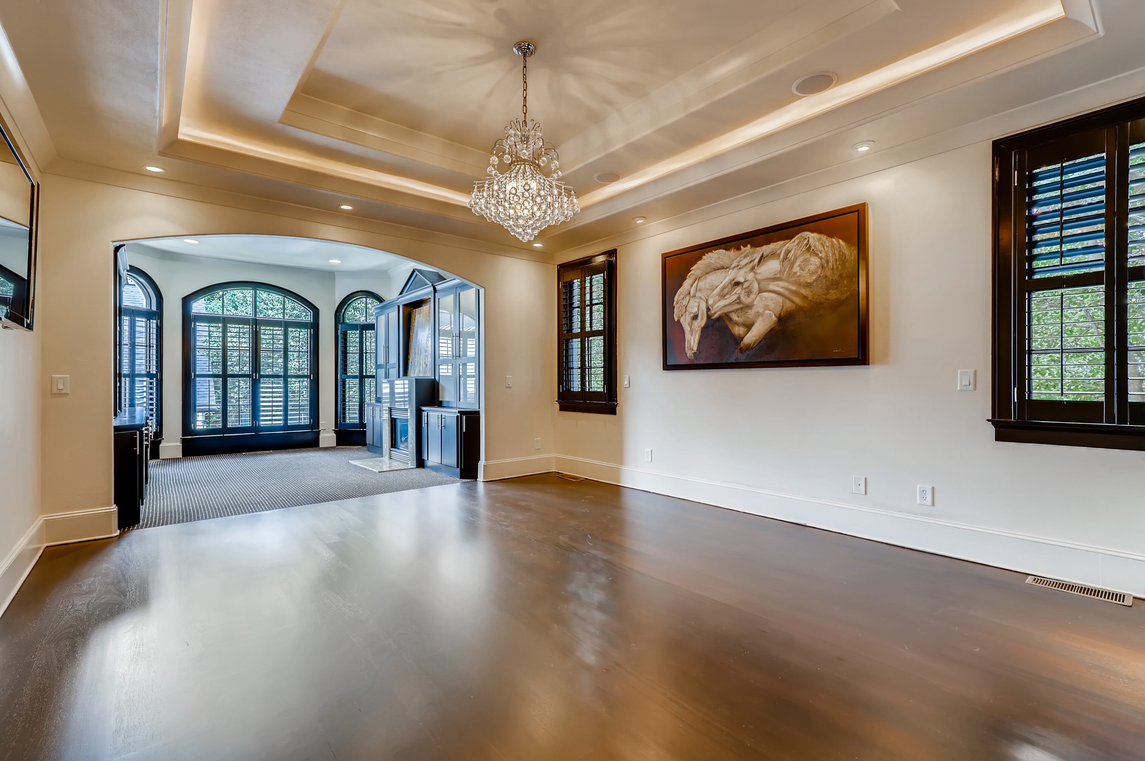 First-floor master bedroom with view to master sitting room with fireplace and bookcases. Text by Diane Arnold