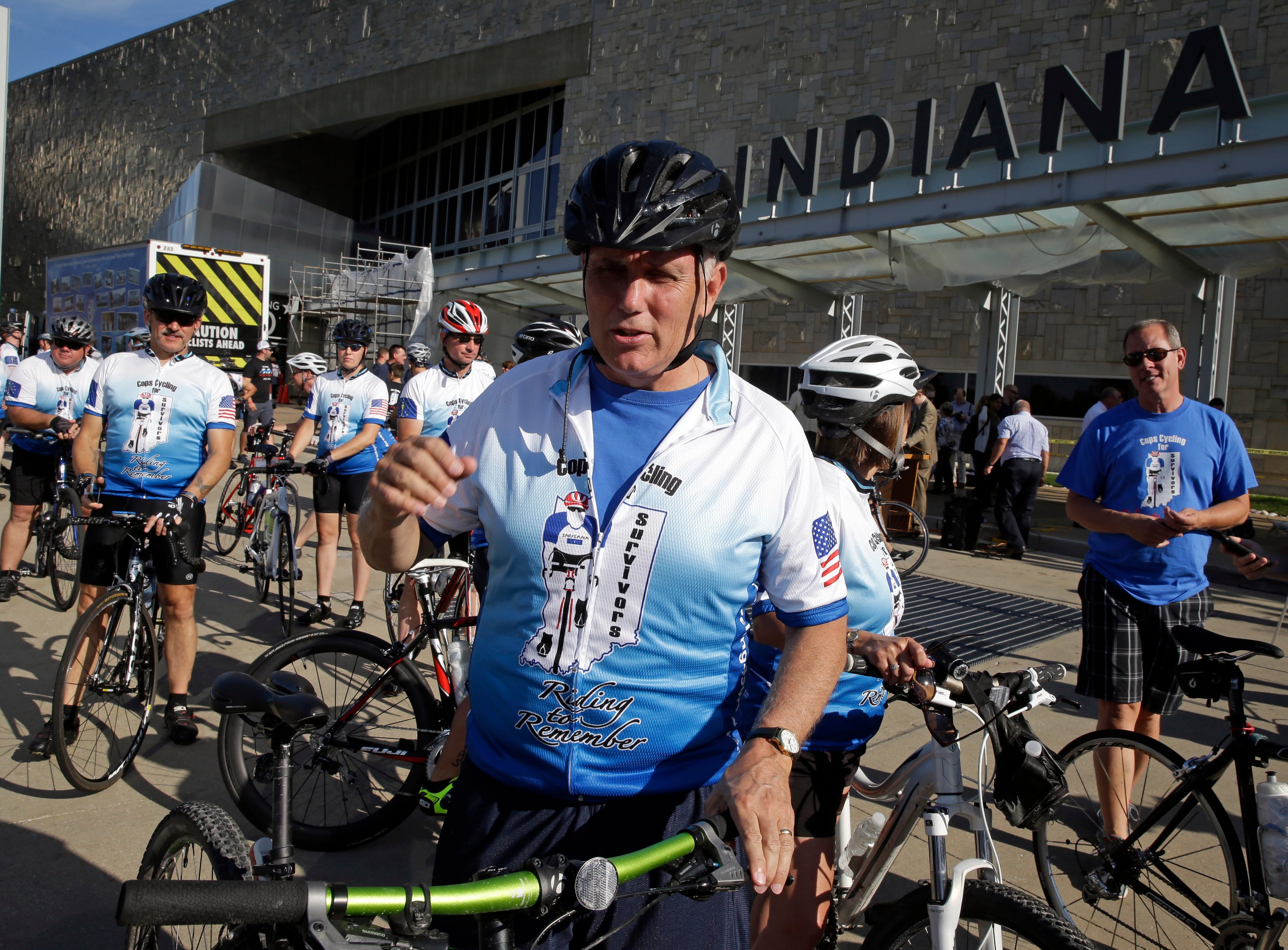 Indiana Gov. Mike Pence prepares to ride the opening segment of the Cops Cycling for Survivors fundraising bike ride in Indianapolis, Monday, July 11, 2016. Pence is being considered as a possible running mate for GOP presidential nominee Donald Trump, who is expected to decide this week, and the two are expected to attend a fundraiser and rally together Tuesday evening. (AP Photo/Michael Conroy)