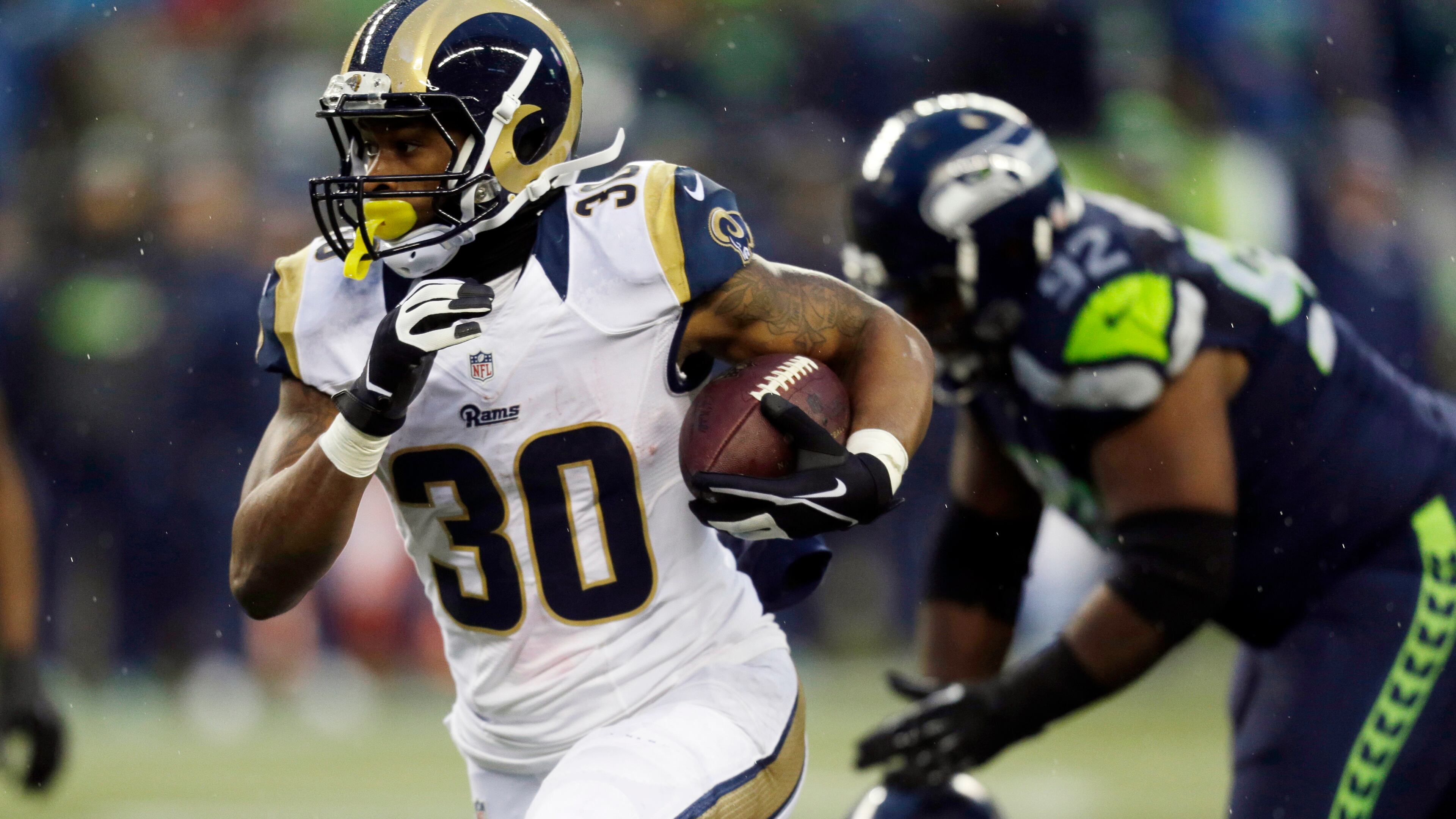 FILE - In this Sunday Dec. 27, 2015, file photo, St. Louis Rams' Todd Gurley runs against the Seattle Seahawks in the second half of an NFL football game in Seattle. Rams phenom Todd Gurley seems to have an inside track for the top pick in 2016, but he will have some stiff competition from wide receivers. (AP Photo/Stephen Brashear, File)