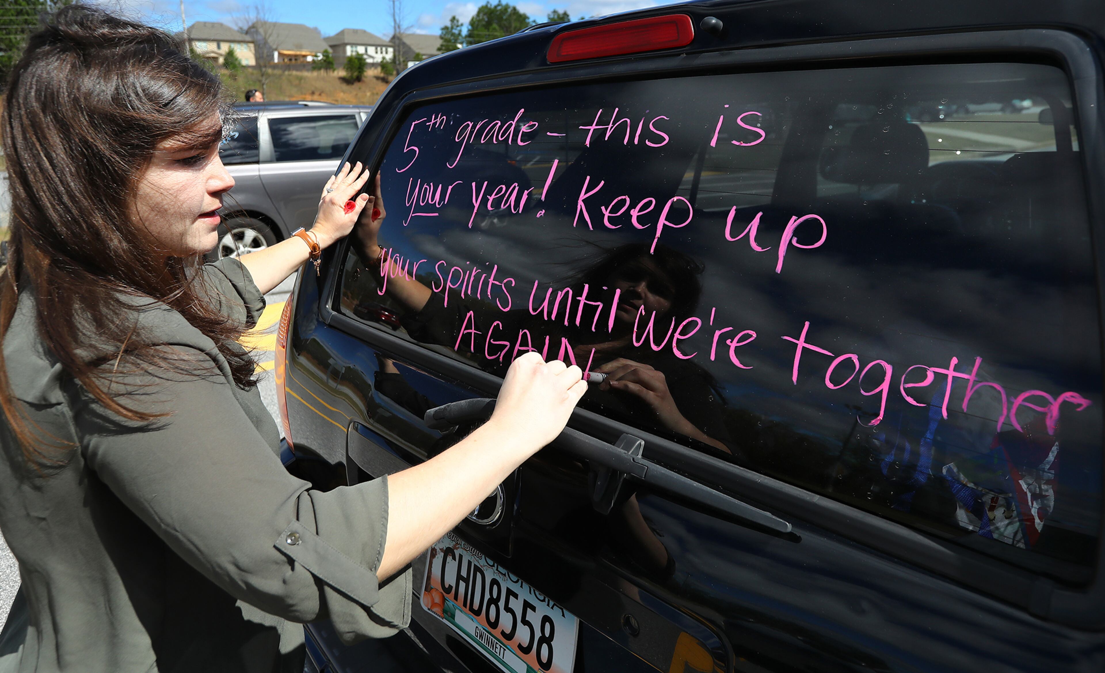 March 25, 2020 Suwanee: Fifth grade teacher Kirsten Zingleman decorates her vehicle as teachers from Roberts Elementary prepare to hold an inspirational school parade driving through area neighborhoods for some face-to-face contact while still maintaining social distance to ease the separation anxiety of their students during the coronavirus on Wednesday, March 25, 2020, in Suwanee. Although distance learning is allowing kids to connect with teachers and get lessons done, the personal touch is missing. Curtis Compton ccompton@ajc.com