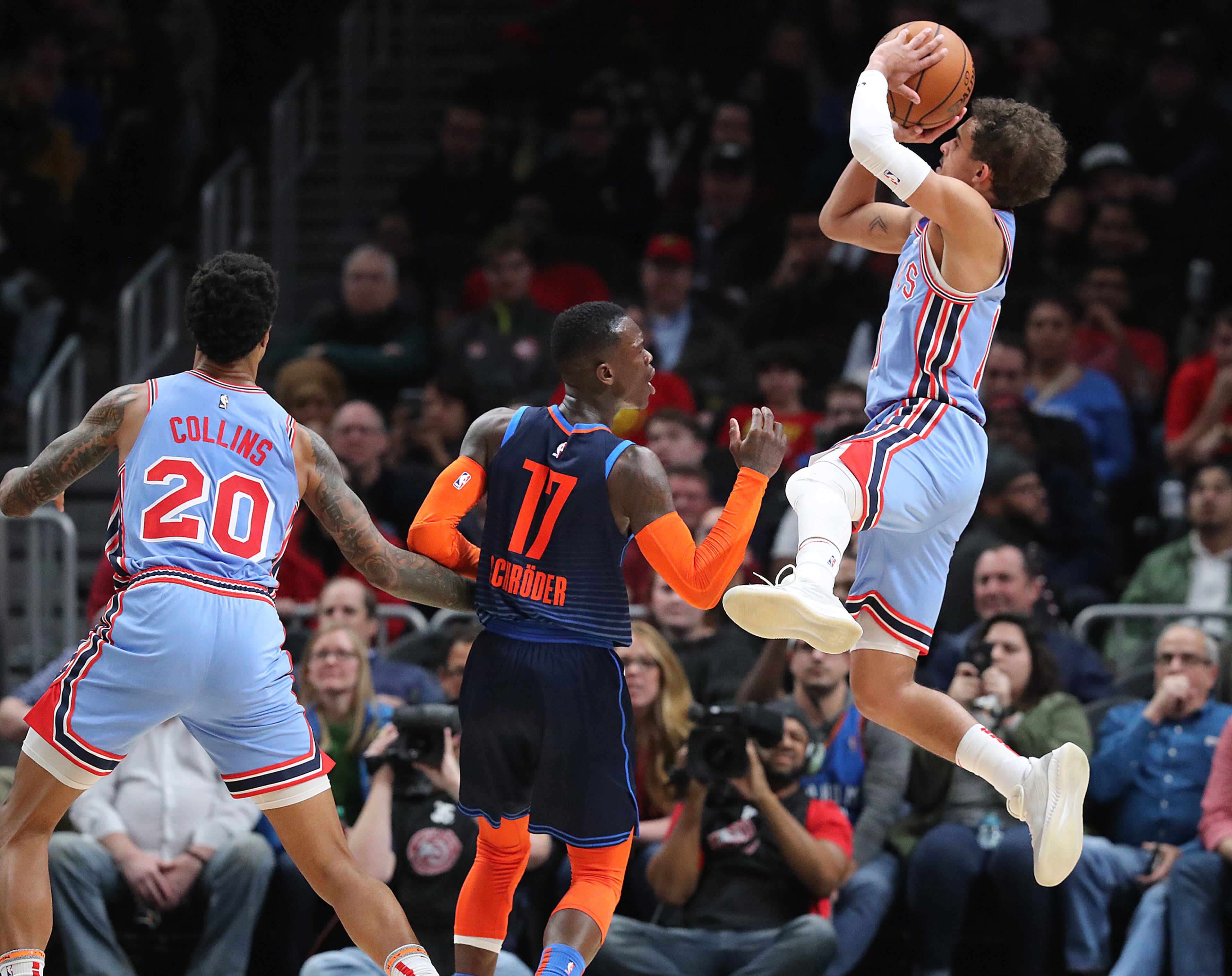 Hawks guard Trae Young shoots over Oklahoma City Thunder guard Dennis Schroder on the way to a 142-126 victory during the second half in a NBA basketball game on Tuesday, Jan. 15, 2019, at State Farm Arena in Atlanta. Curtis Compton/ccompton@ajc.com