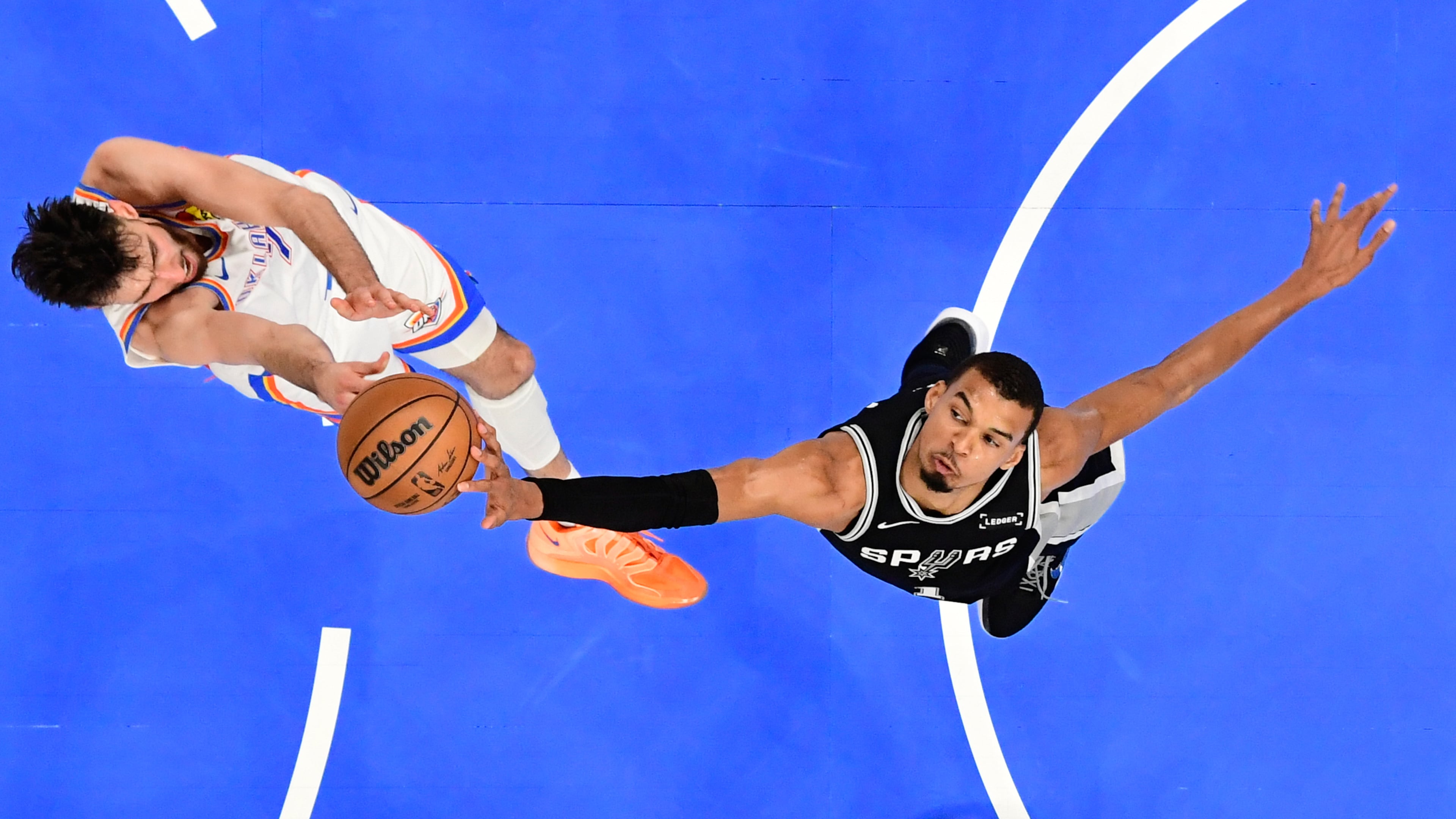 San Antonio Spurs forward Victor Wembanyama, right, blocks a shot by Oklahoma City Thunder center Chet Holmgren during the first half in Game 5 in the Western Conference finals NBA basketball playoffs series, Tuesday, May 26, 2026, in Oklahoma City. (AP Photo/Gerald Leong)