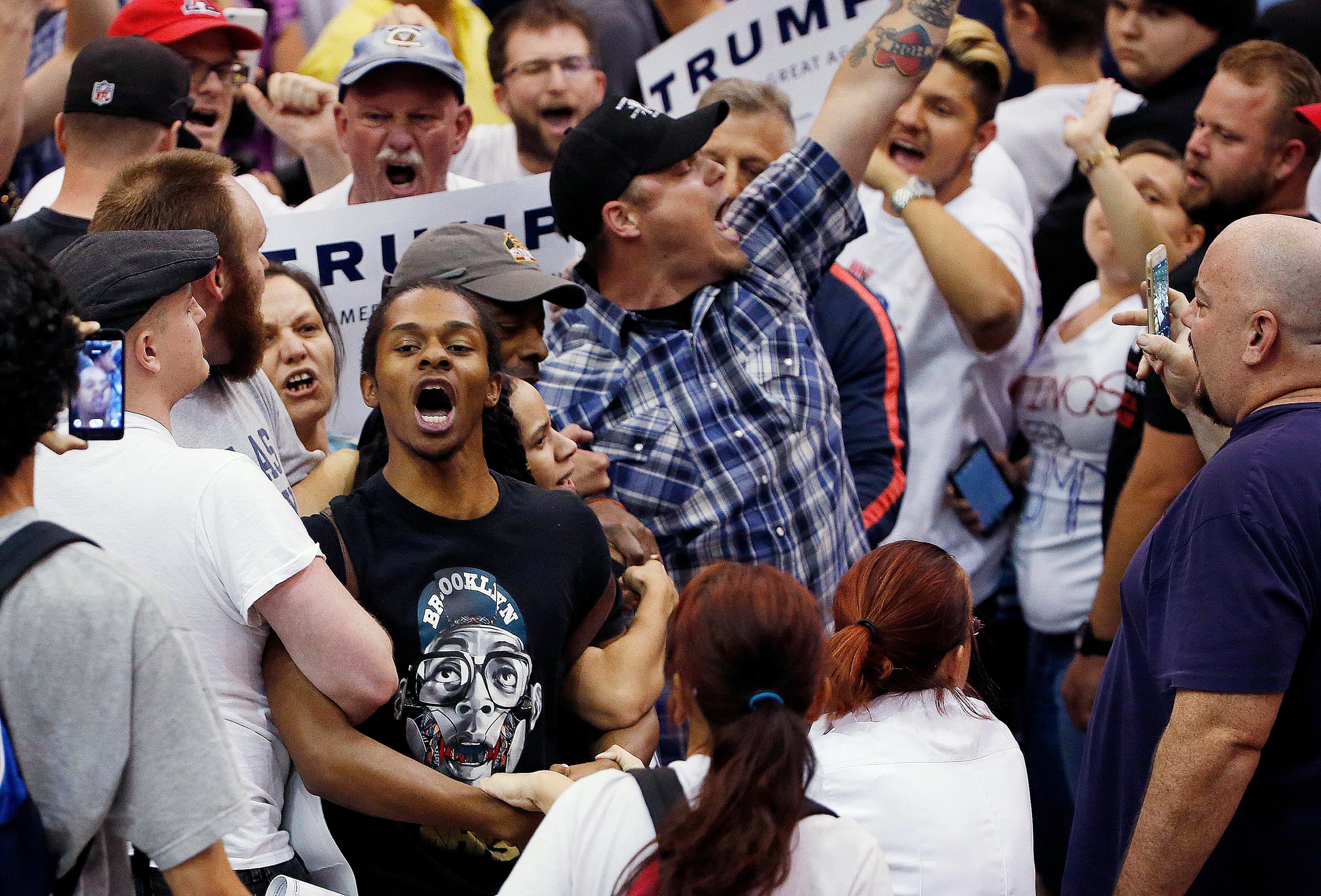 Protesters shout as they are removed from the venue as Republican presidential candidate Donald Trump speaks during a campaign rally Saturday, March 19, 2016, in Tucson, Ariz. (AP Photo/Ross D. Franklin)