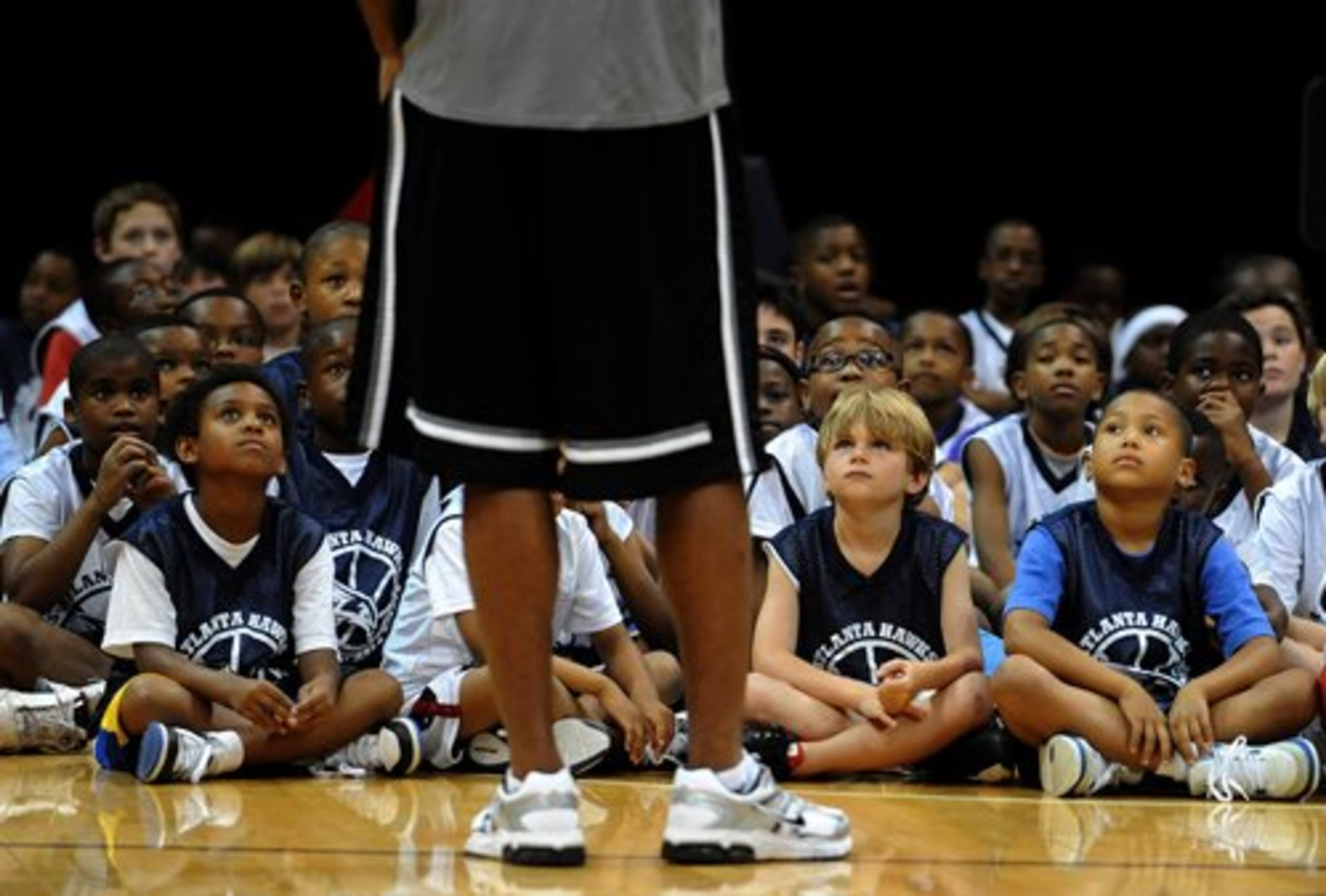 Young basketball players sit and look up at the 245 pound six feet ten inch Atlanta Hawk Al Horford during the Atlanta Hawks Summer Basketball Camp for boys and girls (ages 7-14) on Tuesday, June 15, 2010 at Philips Arena. He answered questions about how he learned the game and talked about all aspects of the game, including; shooting, passing, rebounding, defense, and teamwork.