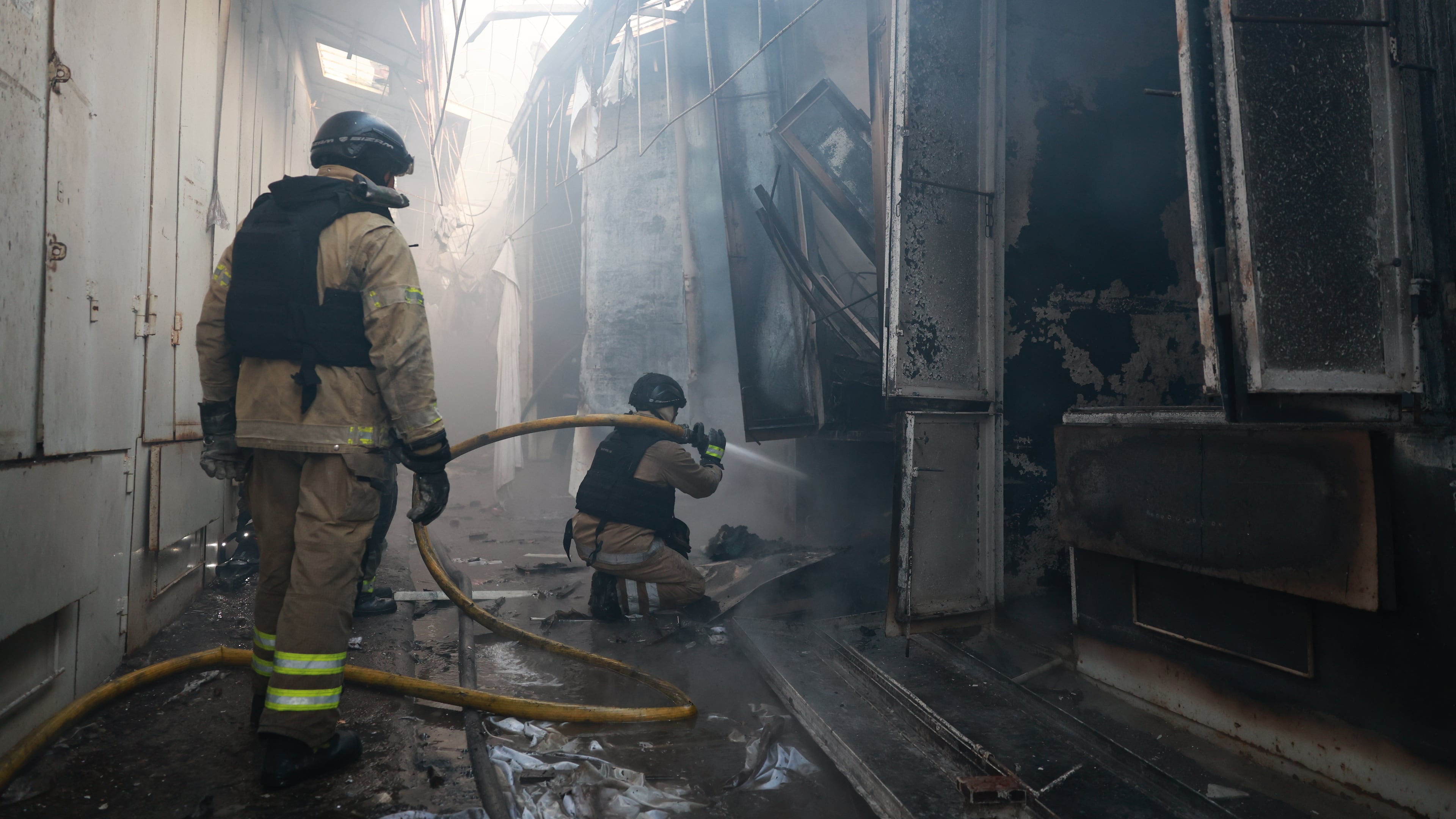 Rescue workers put-out a fire of the central market damaged in a Russian strike on Zaporizhzhia, Ukraine, on Saturday, Sept. 26, 2026. (AP Photo/Kateryna Klochko)