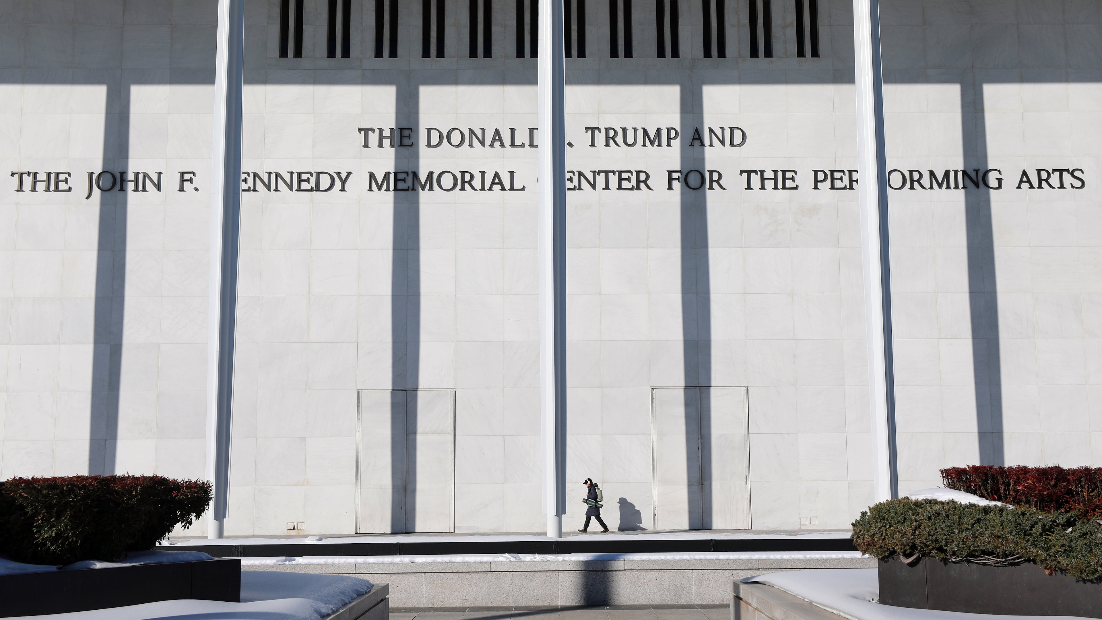 A woman walks outside The John F. Kennedy Memorial Center For The Performing Arts, Monday, Feb. 2, 2026 in Washington. (AP Photo/Rahmat Gul)