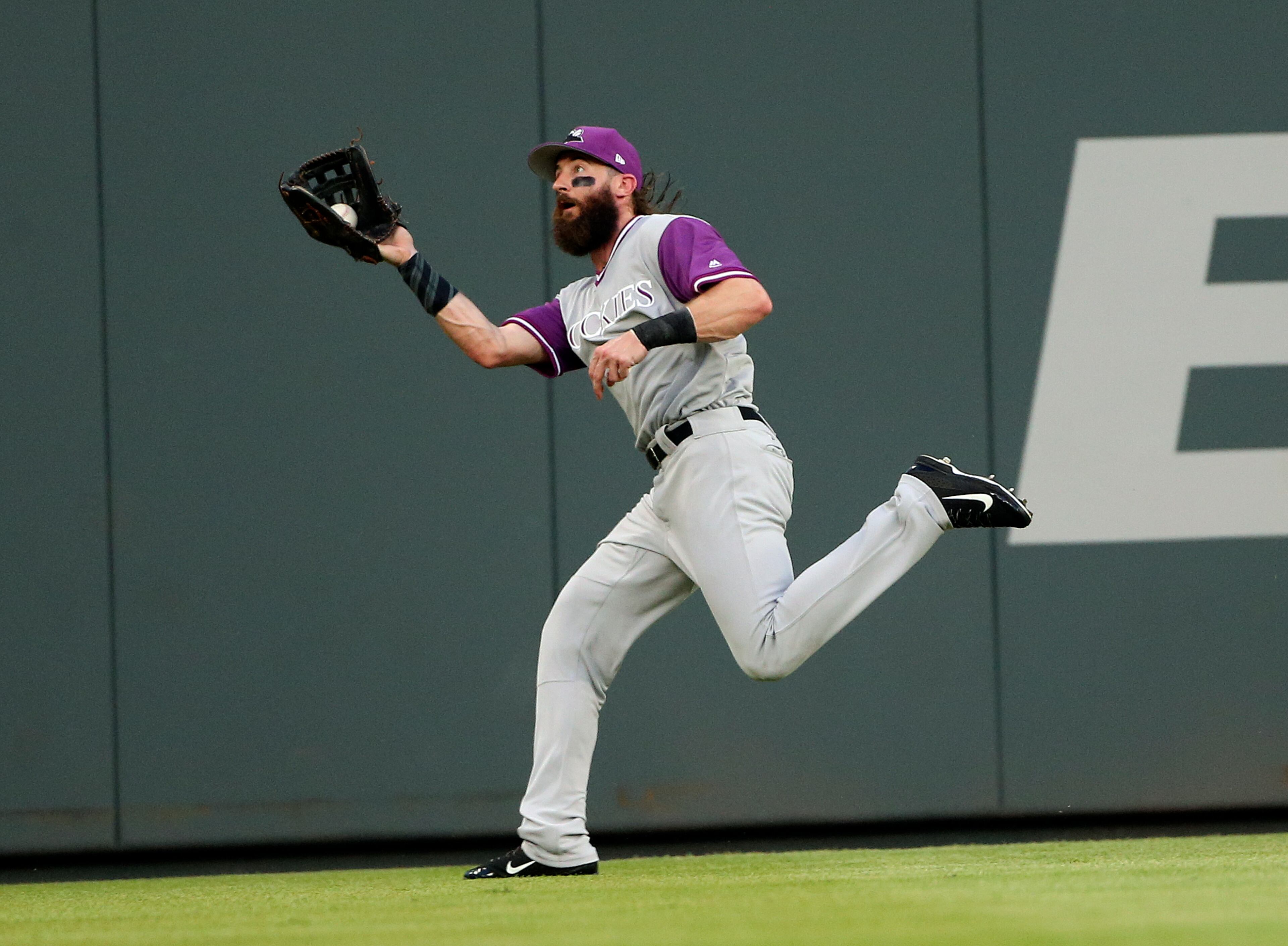 Colorado Rockies center fielder Charlie Blackmon makes a running catch to retire Atlanta Braves' Ender Inciarte during the first inning of a baseball game Friday, Aug. 25, 2017, in Atlanta. (AP Photo/John Bazemore)