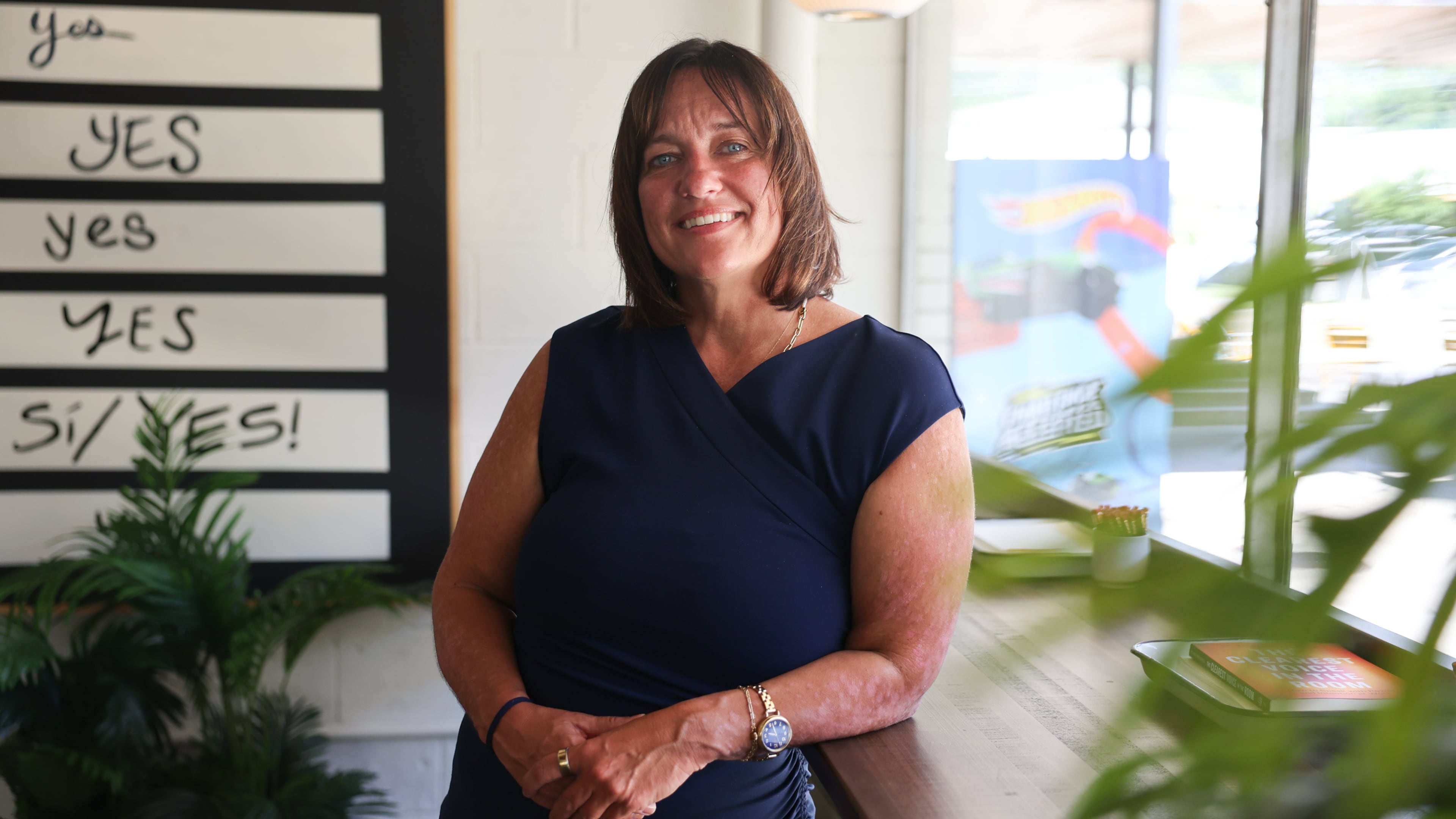Kristine Sickels stands inside the Switchyards Toco Hills co-working space on Monday, Sept. 14, 2026. The author and marketing executive moved to Atlanta nearly 20 years ago. (Arvin Temkar/AJC)