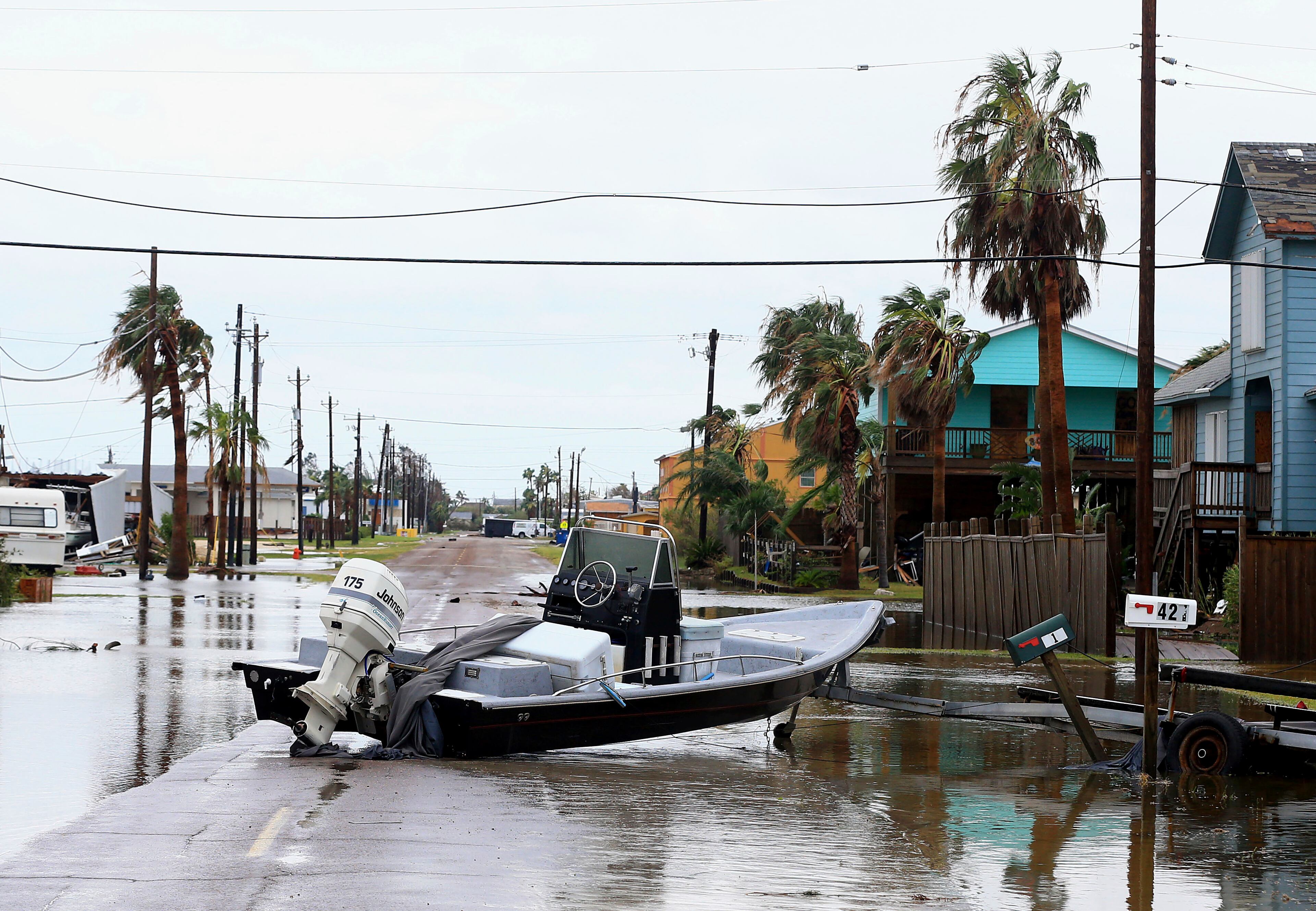 A boat is located in the middle of the street after Hurricane Harvey landed in the Coast Bend area on Saturday, Aug. 26, 2017, in Port Aransas, Texas. The National Hurricane Center has downgraded Harvey from a Category 1 hurricane to a tropical storm. Harvey came ashore Friday along the Texas Gulf Coast as a Category 4 storm with 130 mph winds, the most powerful hurricane to hit the U.S. in more than a decade. (Gabe Hernandez/Corpus Christi Caller-Times via AP)