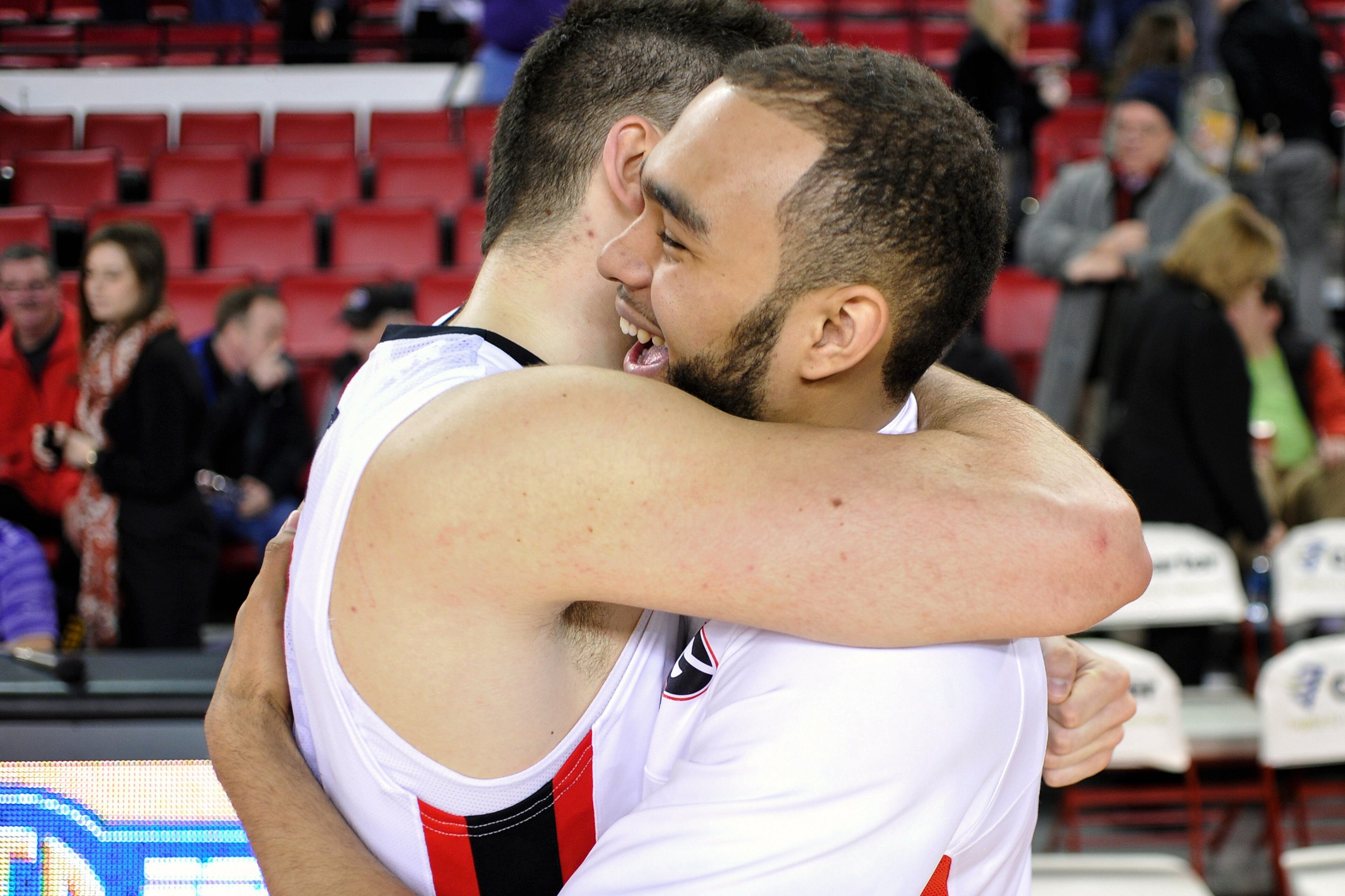 Georgia forward Cameron Forte (11) gets a hug from Georgia forward Nemanja Djurisic (42) after the second half of an NCAA college basketball game on Thursday, Feb. 6, 2014 in Athens, Ga. Georgia won 91-78. (AP Photo/Athens Banner-Herald, AJ Reynolds)