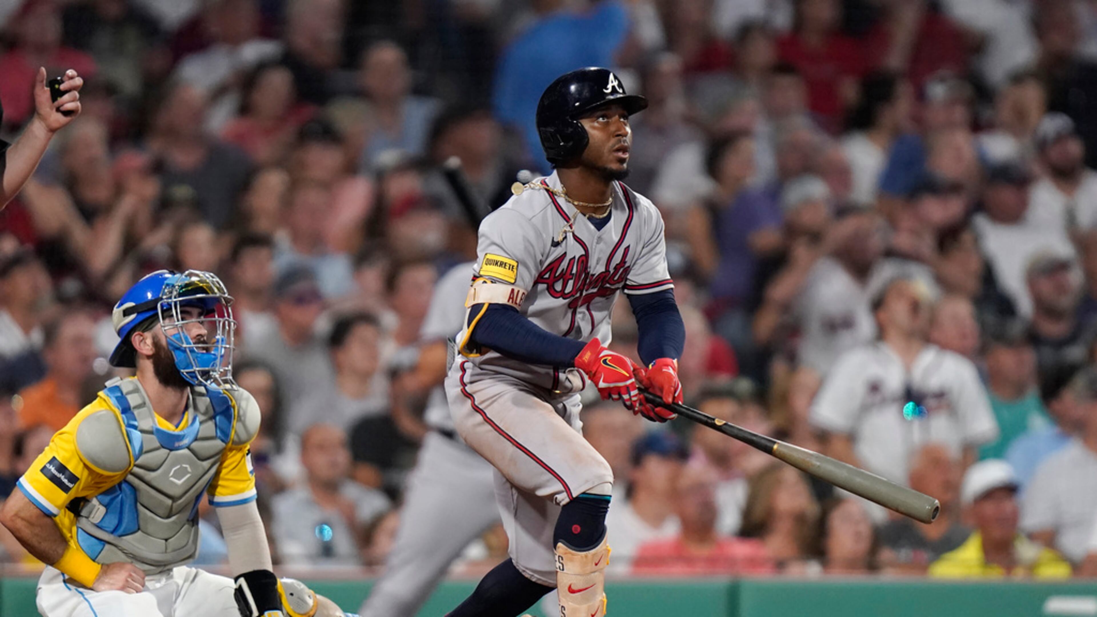 Atlanta Braves' Ozzie Albies, right, watches the flight of his three-run home run as Boston Red Sox's Connor Wong, left, looks on in the sixth inning of a baseball game, Wednesday, July 26, 2023, in Boston. (AP Photo/Steven Senne)
