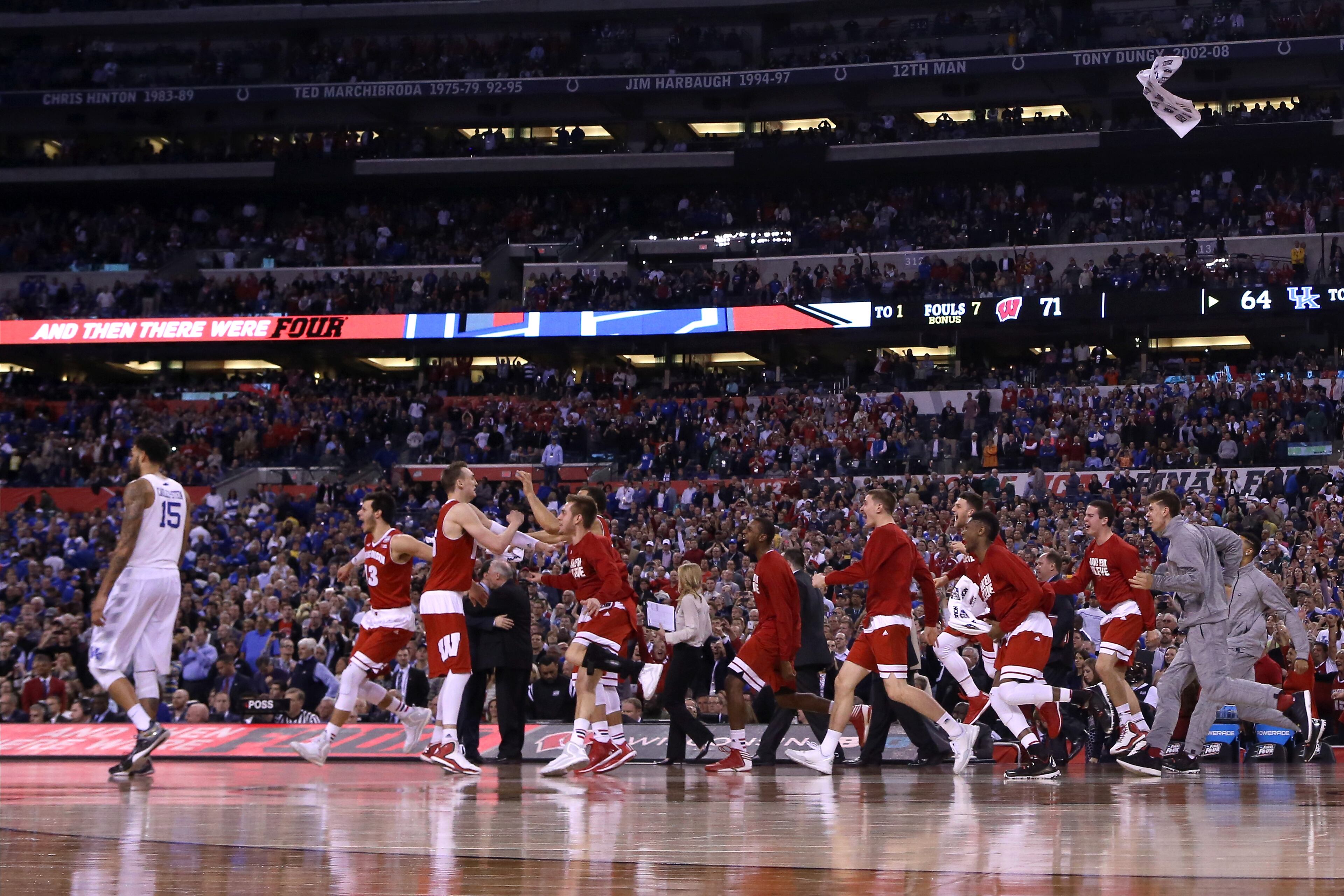 INDIANAPOLIS, IN - APRIL 04: Willie Cauley-Stein #15 of the Kentucky Wildcats walks off the court as the Wisconsin Badgers celebrate during the NCAA Men's Final Four Semifinal at Lucas Oil Stadium on April 4, 2015 in Indianapolis, Indiana. Wisconsin defeated Kentucky 71-64. (Photo by Streeter Lecka/Getty Images)