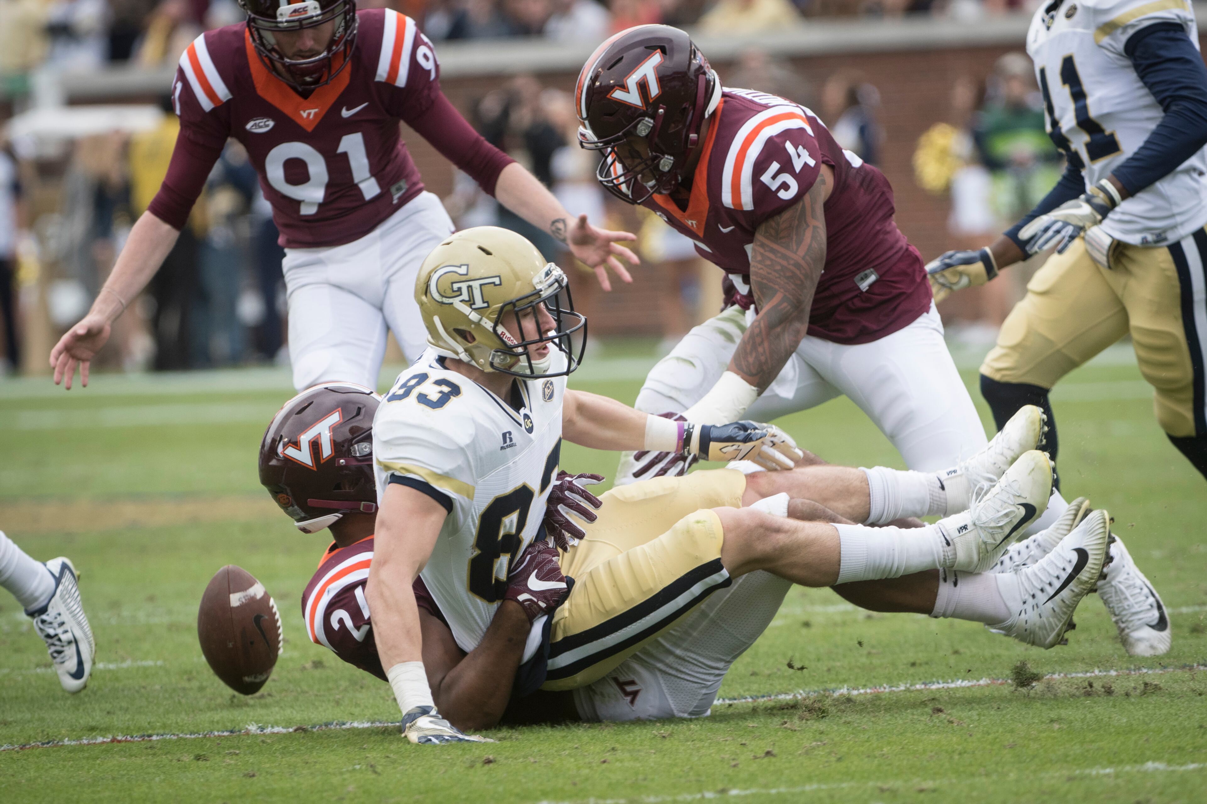 Georgia Tech wide receiver Brad Stewart (83) fumbles as he is brought down by Virginia Tech linebacker Anthony Shegog (24) during the first half of a football game on Saturday, Nov.11, 2017, in Atlanta. (Photo/John Amis)