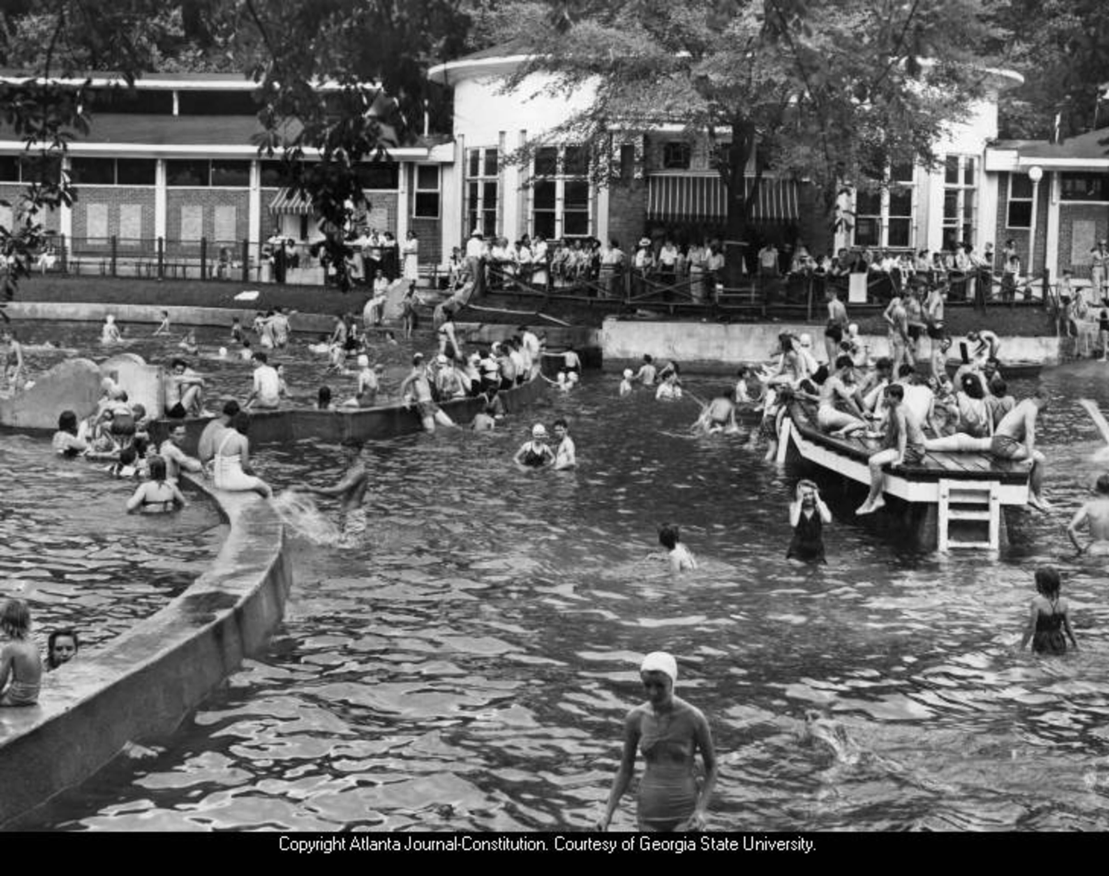 1949 -- Original caption: "This scene at Grant Park Pool was typical as holiday crowds, pleasure-bent, splashes their way to freedom from July heat. Young, old and the in-betweens were at the pools early and stayed until the lights went out. Everybody had a good time and there were no serious casualties." TAYLOR MOORMAN / AJC FILE