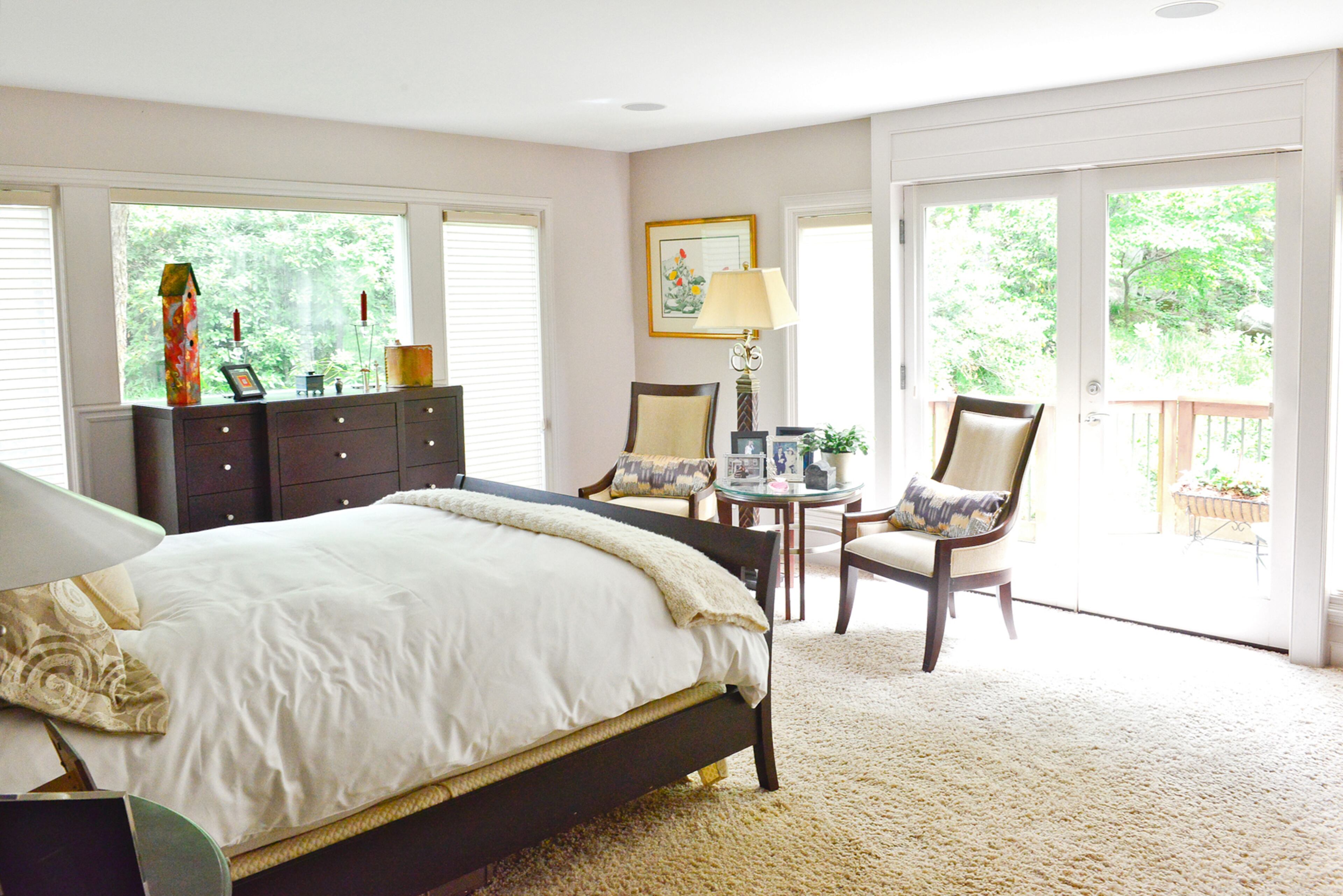 Large windows and French doors leading to a deck help create a tranquil master retreat for homeowners Judy Mozen and Randy Urquhart.