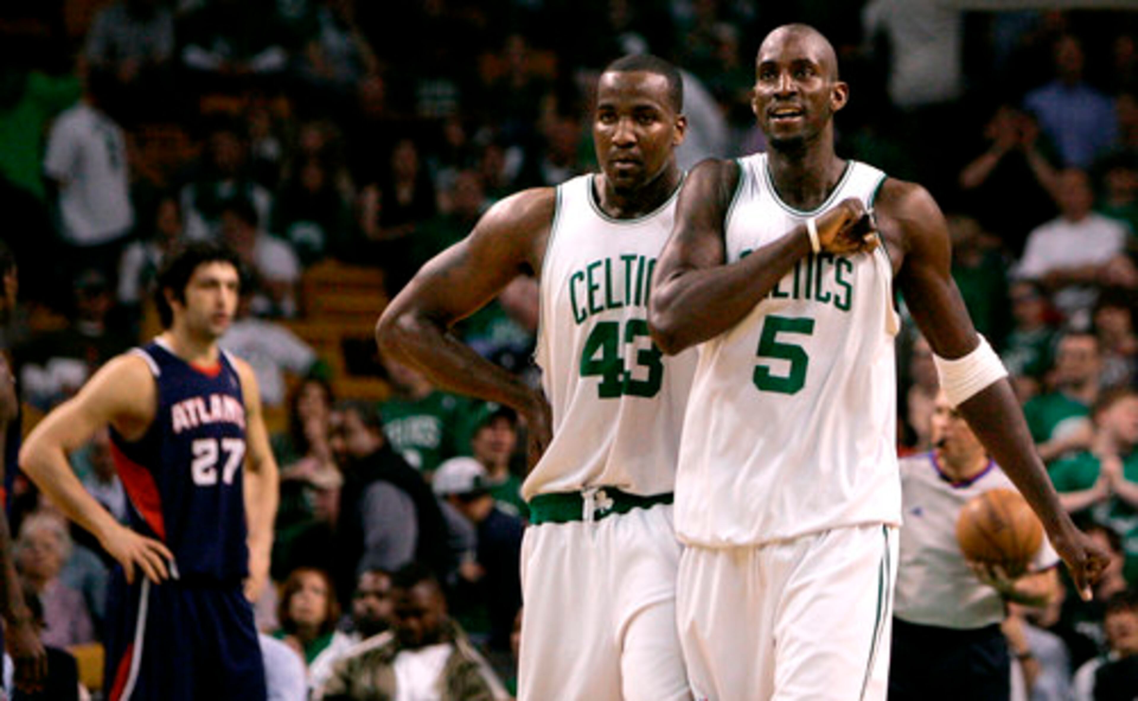 Celtics forward Kevin Garnett (5) pounds his chest while walking up the floor with teammate Kendrick Perkins (43) during Boston's 25-point win.