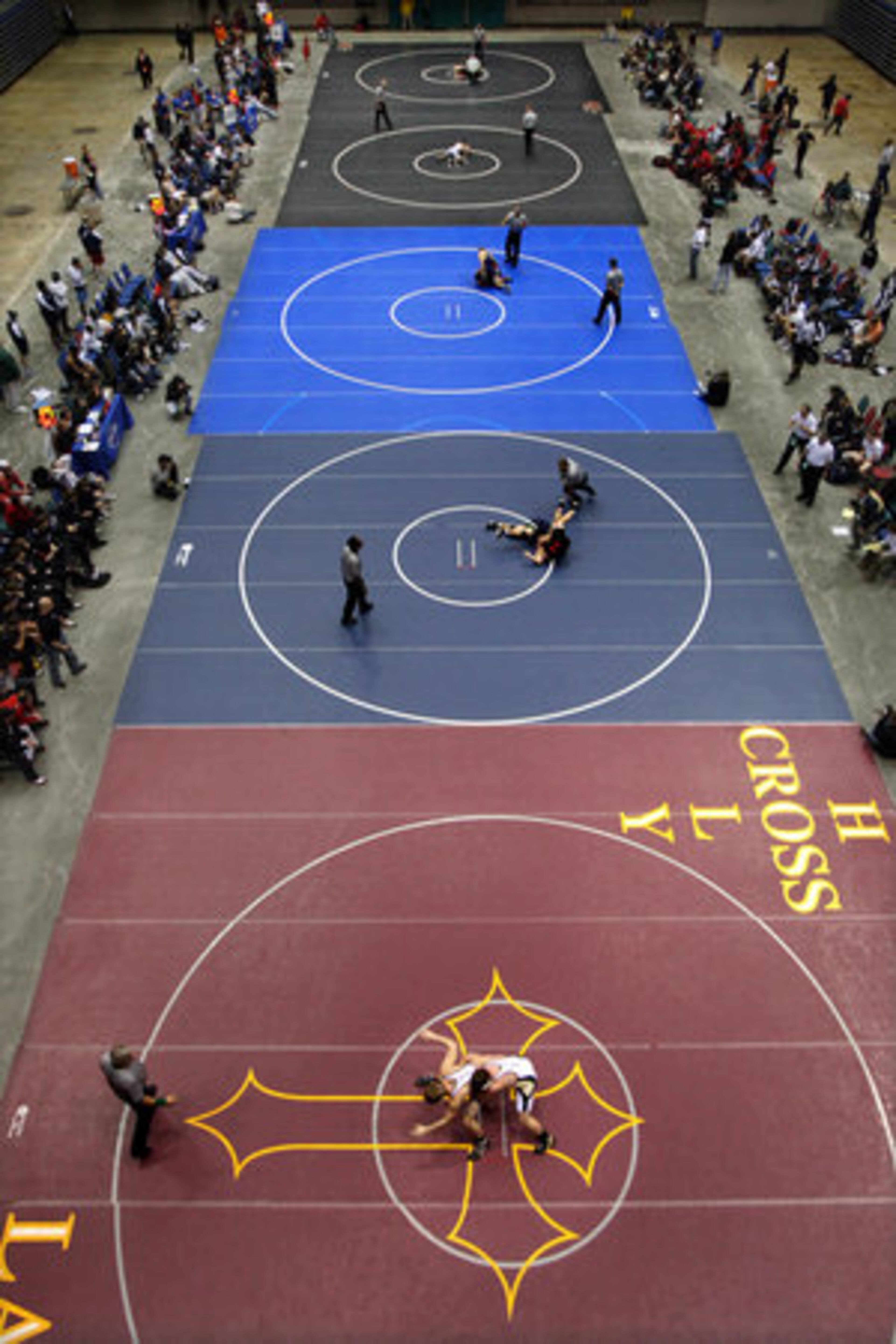 Wrestlers fill the mats on all five rings during the event at the Macon Centreplex and Coliseum.