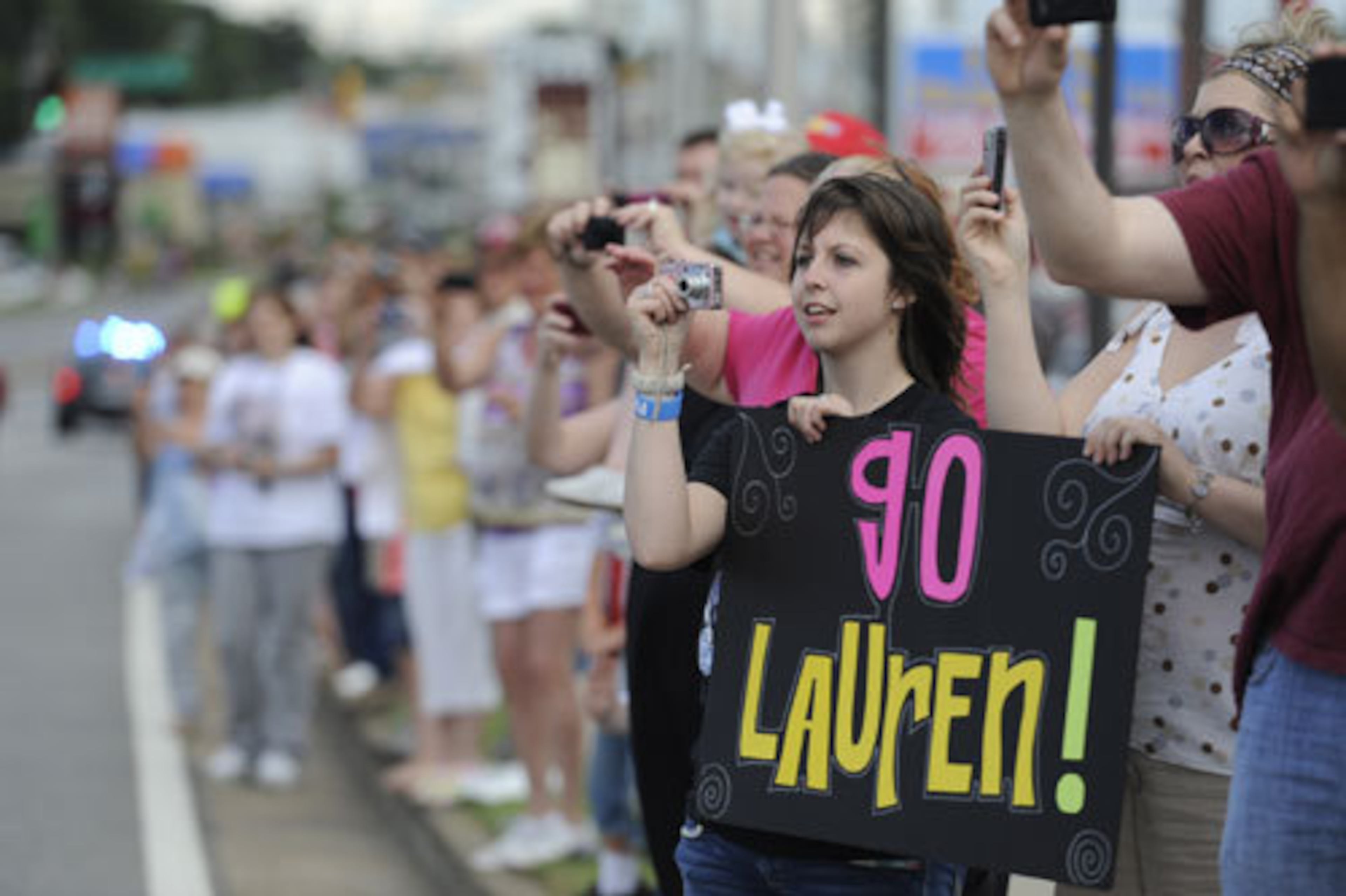 Hundreds of friends, classmates, fans and supporters cheer as Suddeth rides down Battlefield Parkway during a parade down in Rossville, Ga.