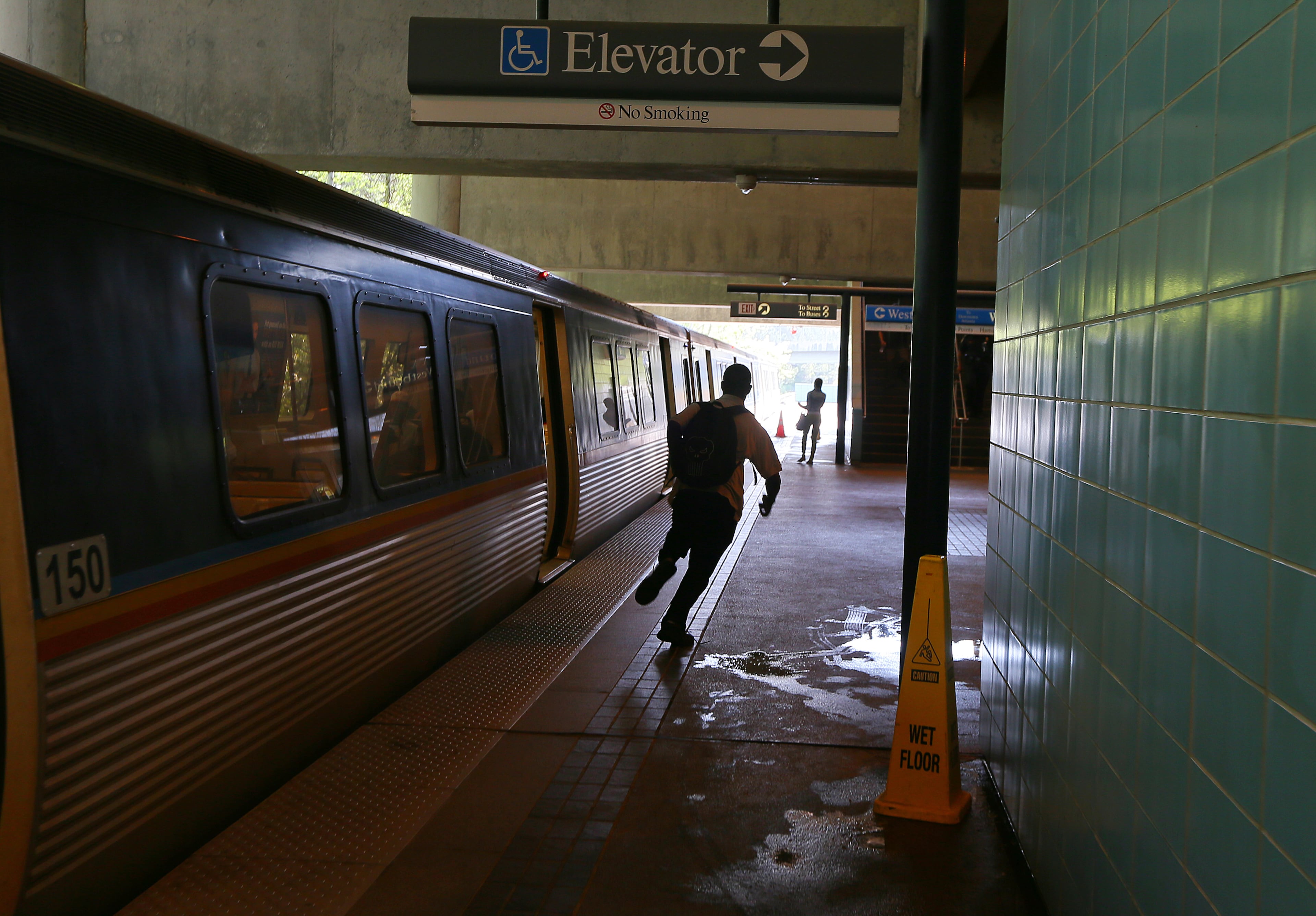 After catching a bus near his Stone Mountain home, Omar runs to catch his MARTA train at the Indian Creek Station to continue the second leg of his two-hour journey to work.