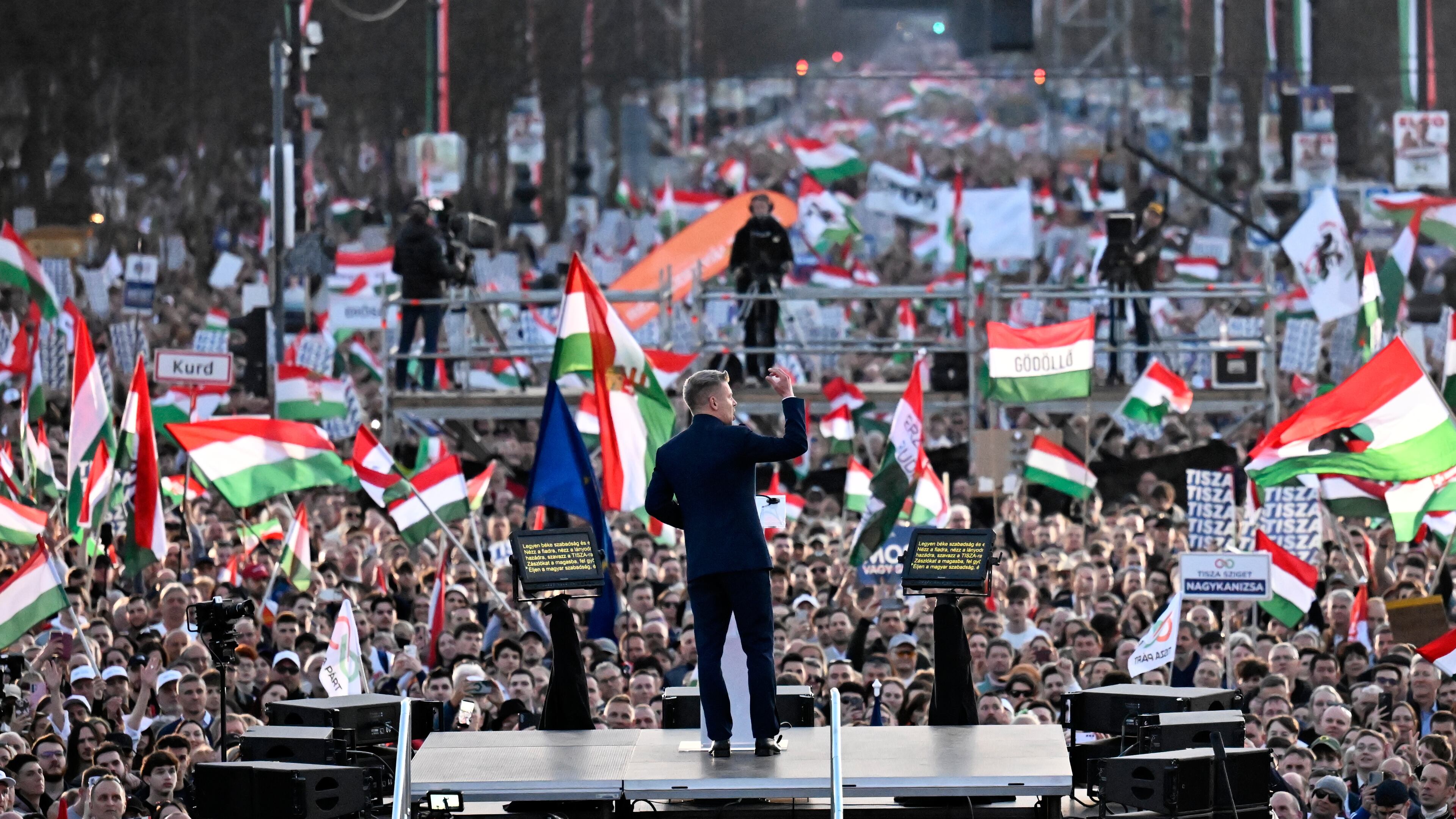 Opposition leader Peter Magyar, center, addresses his supporters during a march in Budapest, Sunday, March 15, 2026. (AP Photo/Denes Erdos)