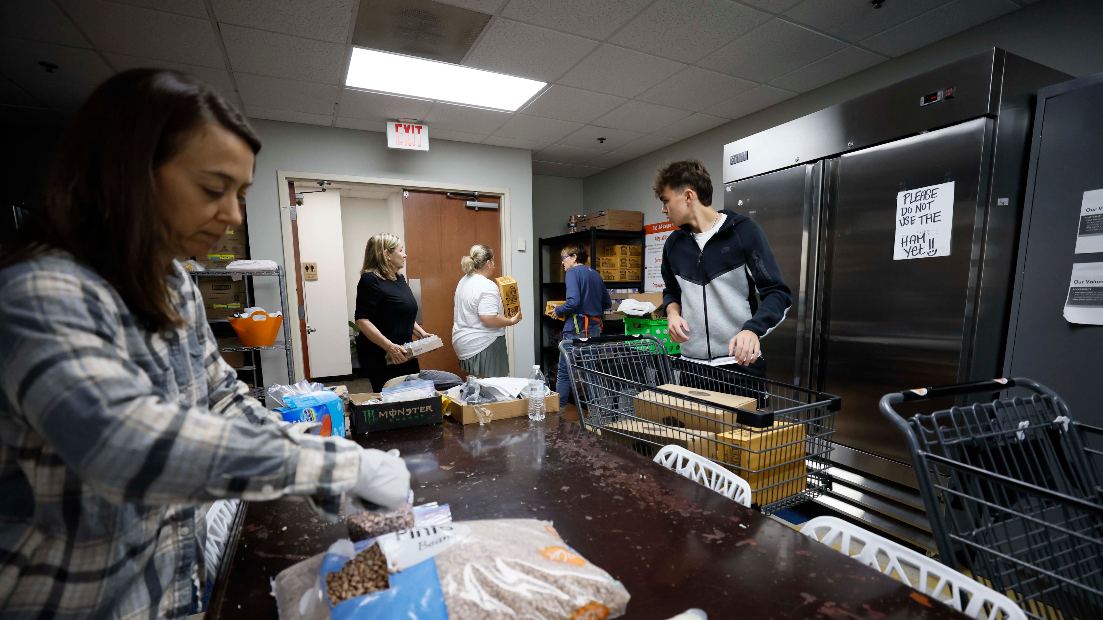 Volunteers from the Latin American Association organize boxes and bags of food in November to help the rising number of families who have lost incomes due to family members being detained by U.S. Immigration and Customs Enforcement. (Miguel Martinez/AJC 2025)