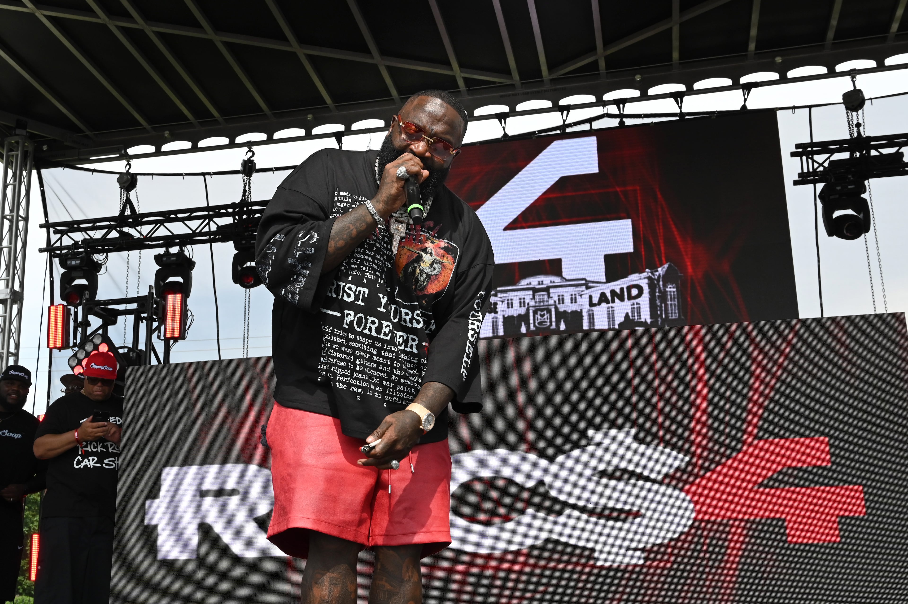 Rick Ross performs during the 4th Annual Rick Ross Car and Bike Show, Saturday, June 7, 2025, in Fayetteville. The 4th Annual Rick Ross Car and Bike Show will include a vendor market with more than 30 vendors, food trucks, fleets of classic/custom automobiles, luxury vehicles, boats, RVs and trailers on the front of the mansion. Stage performances include Plies, Ross' new signee Nino Breeze and Ross himself. (Hyosub Shin / AJC)