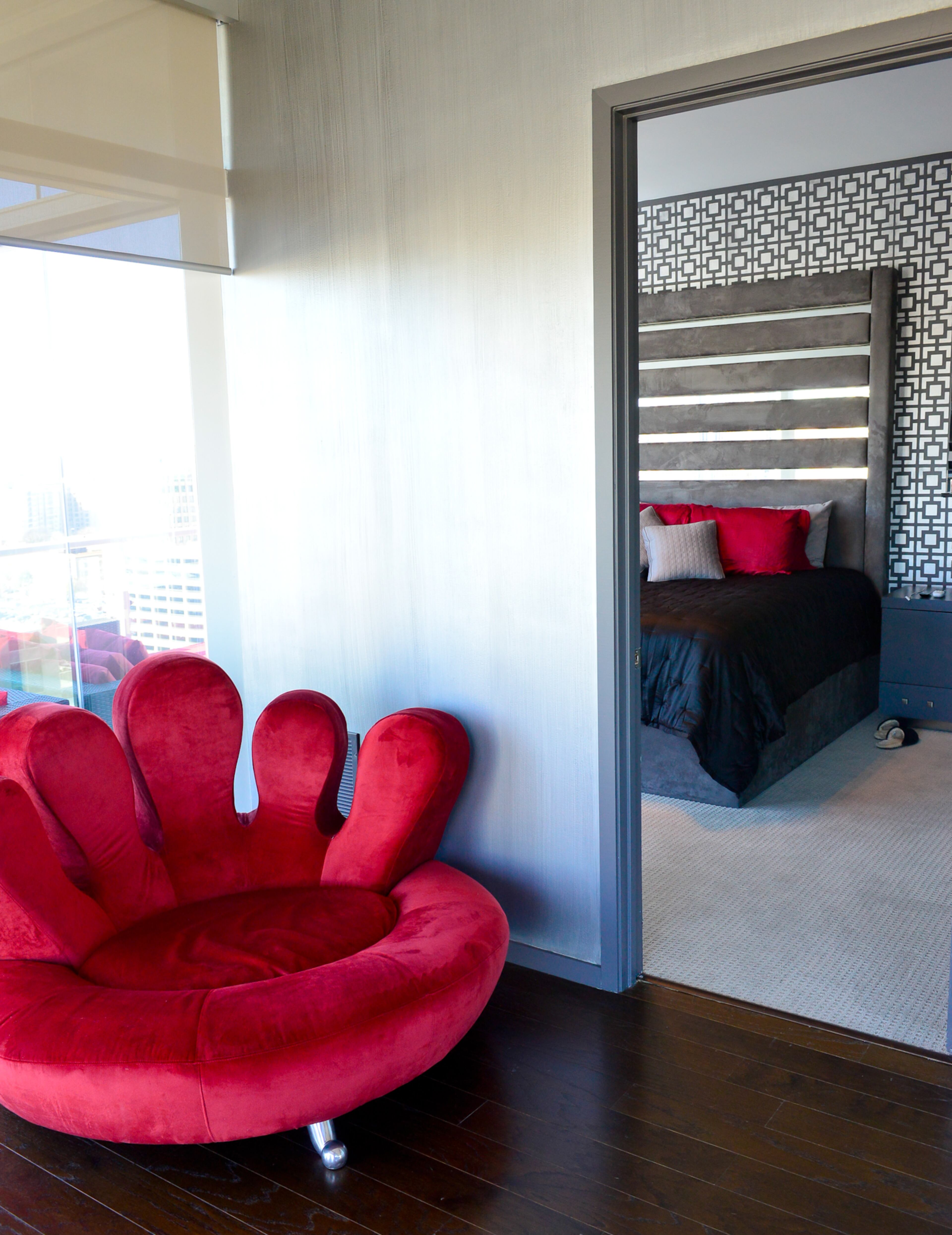 The chair was once covered in white leather, but Jordan Schafer had it re-upholstered in red velvet to provide a comfortable place to sit for him and his dog. Schafer said Atlanta decorative artist Kathy Hynes stenciled the design on the master bedroom's walls. -- Text by Lori Johnston.