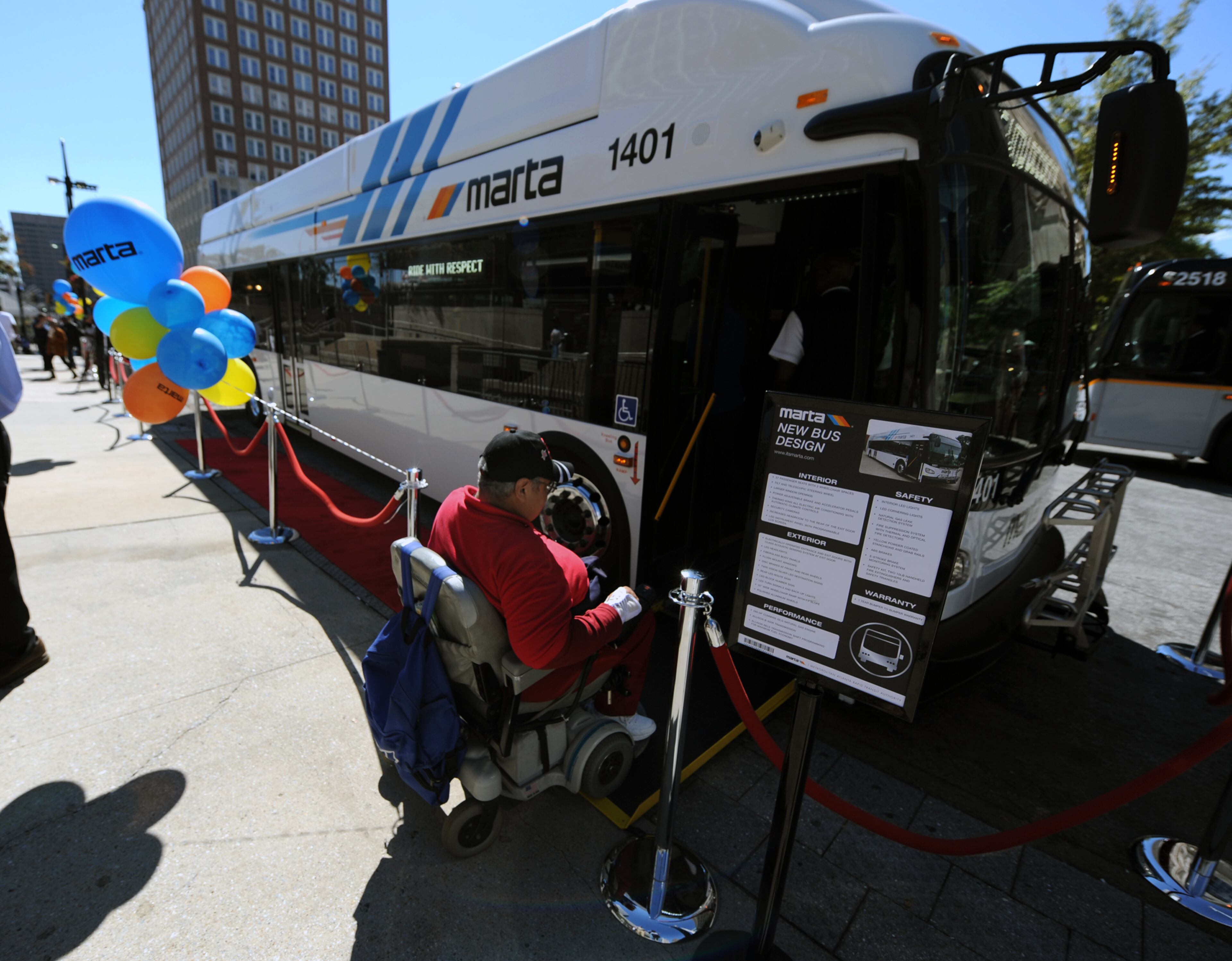 Walterine Jones rides her wheelchair up the ramp into the new MARTA bus at the Five Points Marta Station in Downtown Atlanta on Thursday, October 10, 2013. MARTA has ordered 88 buses that will replace older vehicles that are being retired. The total order is for 265 new buses over the next three years. Among the standard features on the new buses are increased headroom at the wider rear exit door and air conditioning with automatic climate controls.