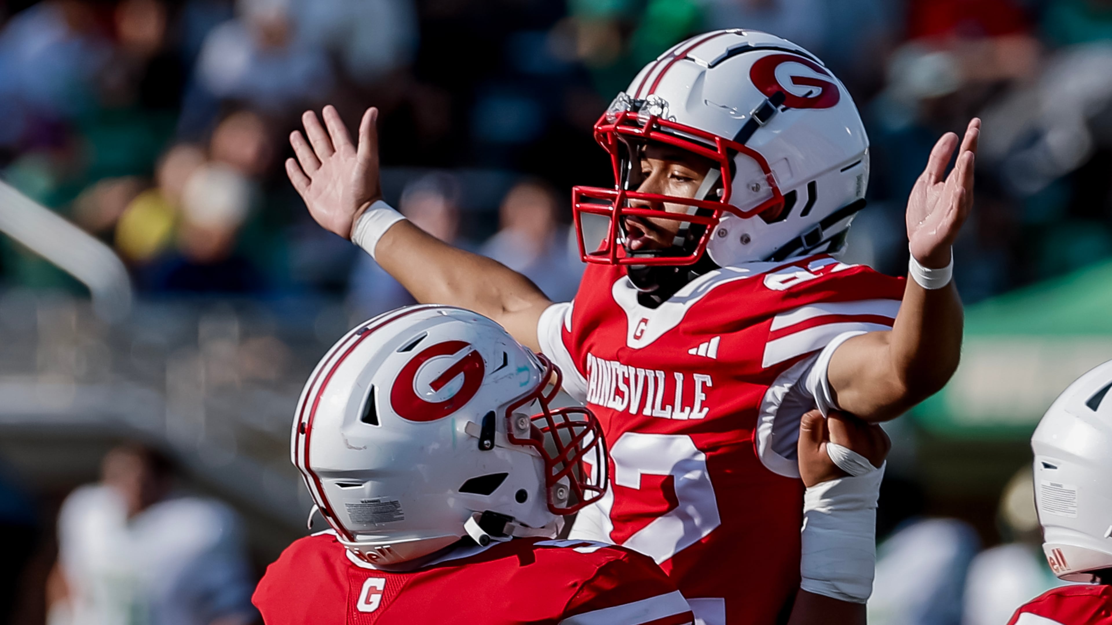 Gainesville kicker Dwayne Carter III (right) celebrates his field goal with Ethan Aguirre during the first half against host Buford on Saturday, Aug. 22, 2026. Carter converted both of his field goal attempts in the 39-19 loss to the Wolves. (Erik S. Lesser for the AJC)