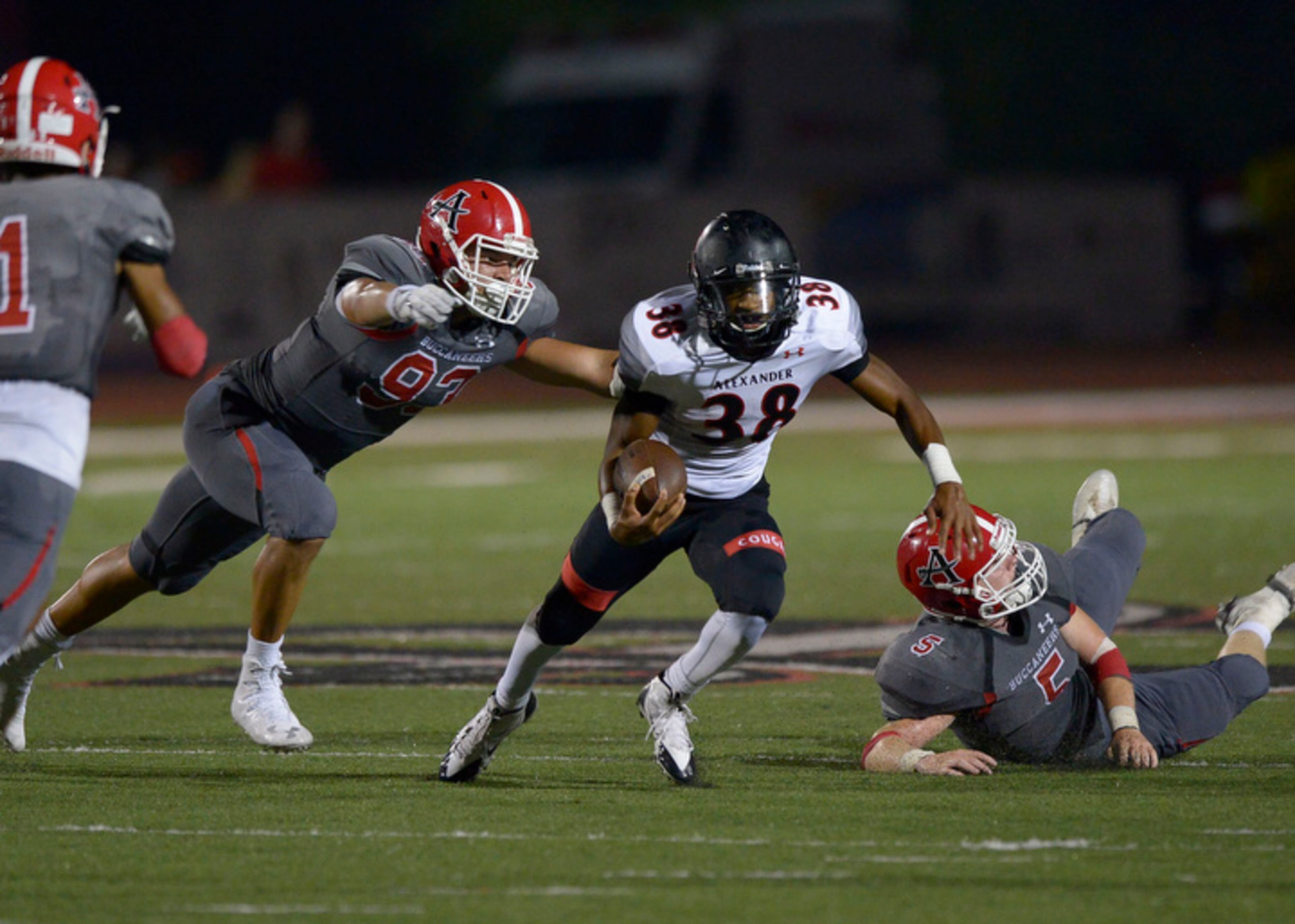 Alexander junior RB Quentin Brown (38) avoids being tackled by Allatoona senior DE Royce Francis (93) and senior MLB Micael Romans (5) during a play in the second half of their game at Allatoona Friday, August 25, 2017. Special/Daniel Varnado